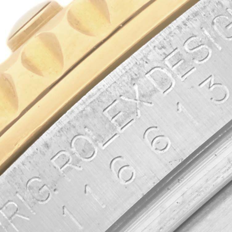 The image shows a close-up of the side of a Rolex Submariner 116613LB Men's Steel and Gold (two tone) Blue Dial 116613LB Men's Steel and Gold (two tone) Blue Dial, highlighting the bezel and case with engraved details.