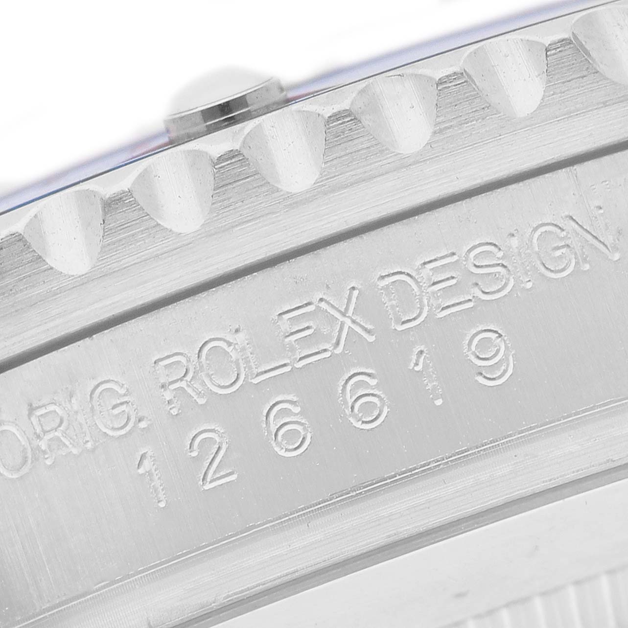 The image shows a detailed close-up of the bezel and serial engraving on the Rolex Submariner 126619 Men's White Gold Black Dial watch.