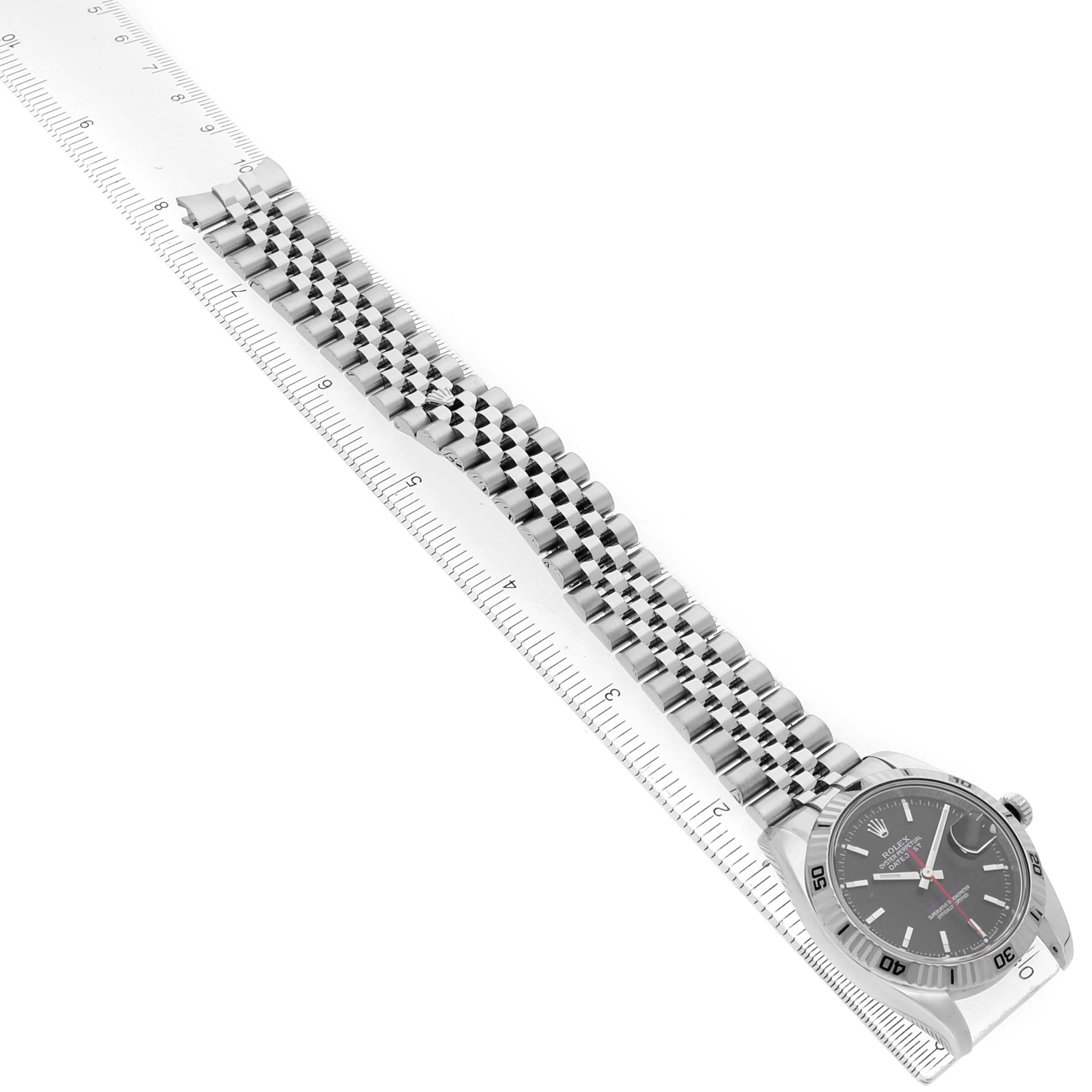 The image shows a side angle of the Rolex Turn-o-Graph 116264 Men's Stainless Steel Black Dial watch, highlighting the face and entire band alongside a ruler.