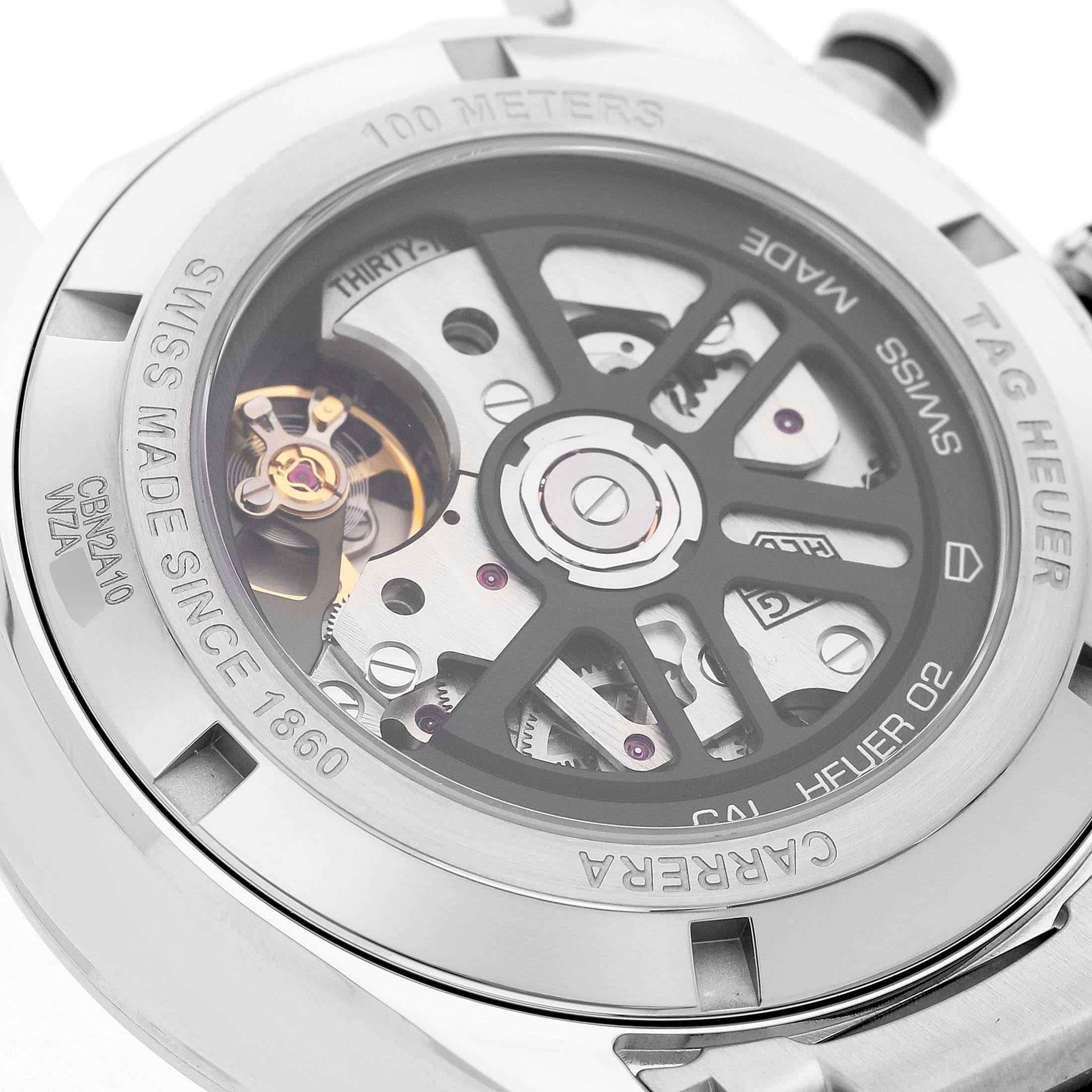 The image shows the back of the Tag Heuer Carrera CBN2A10.BA0643 Men's Stainless Steel Green Dial watch, highlighting the movement and rotor through a transparent case back.