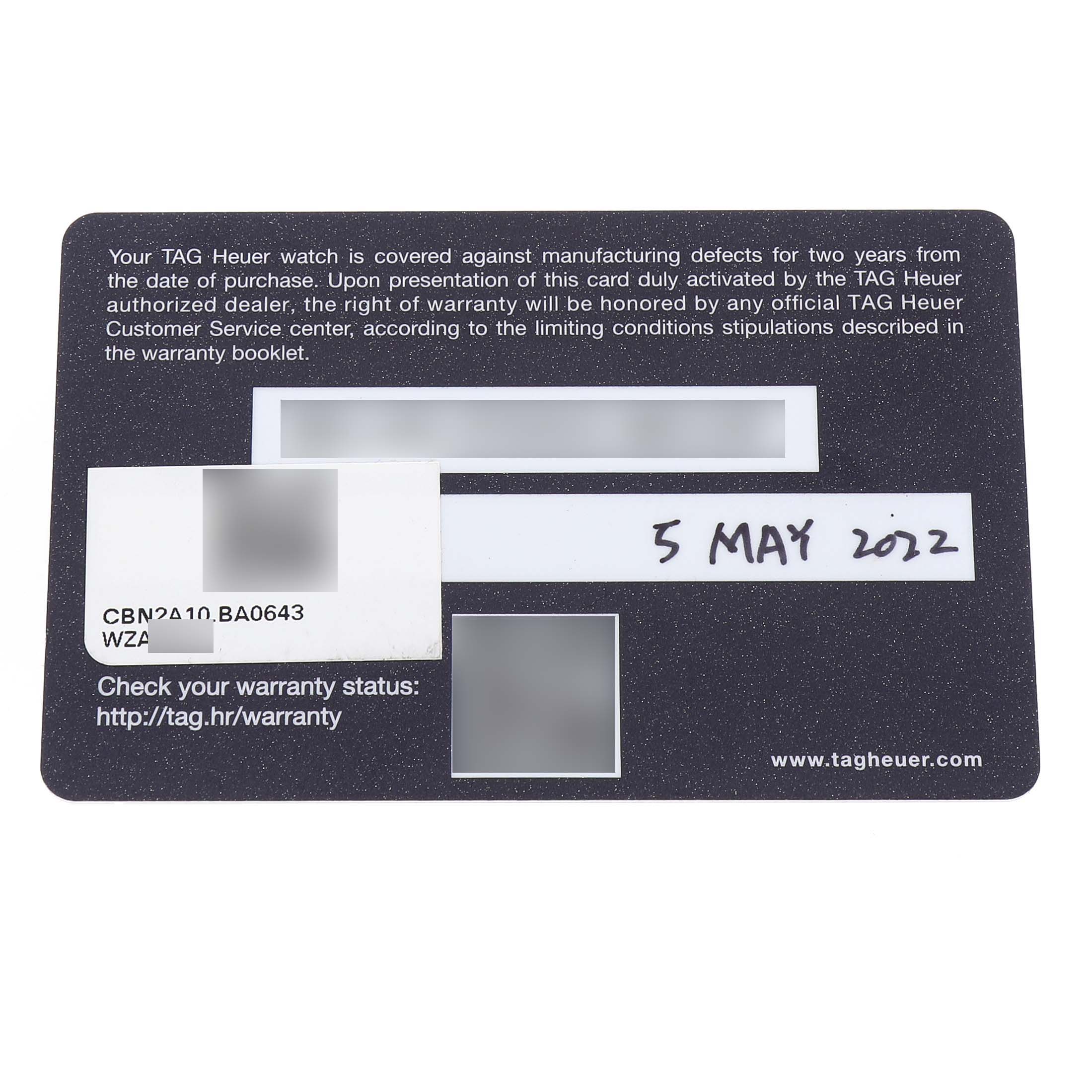 The image shows a warranty card for the Tag Heuer Carrera CBN2A10.BA0643 Men's Stainless Steel Green Dial model, with text and a date written on it.