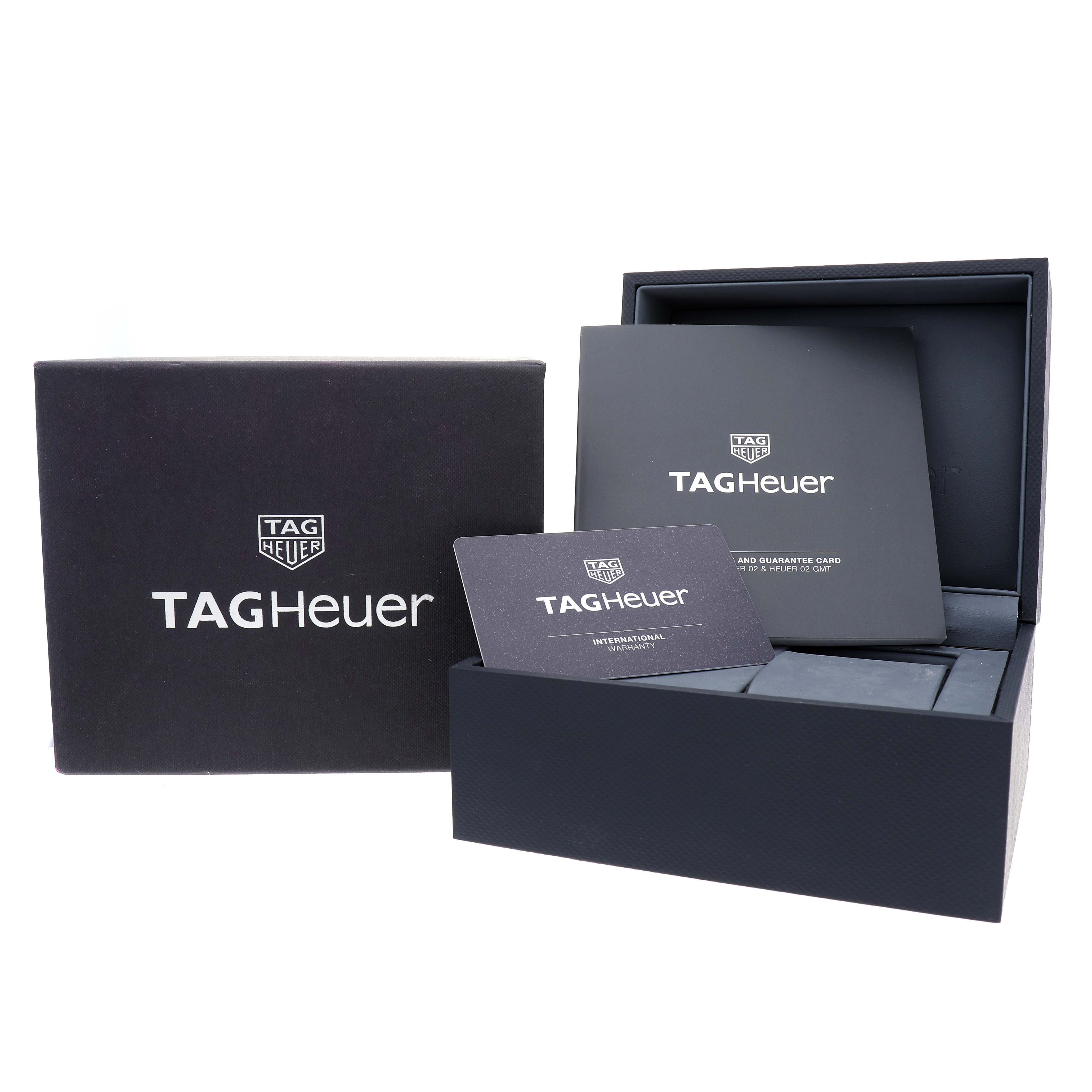 The image shows the Tag Heuer Carrera CBN2A10.BA0643 Men's Stainless Steel Green Dial packaging, warranty card, and manuals, viewed from a front angle.