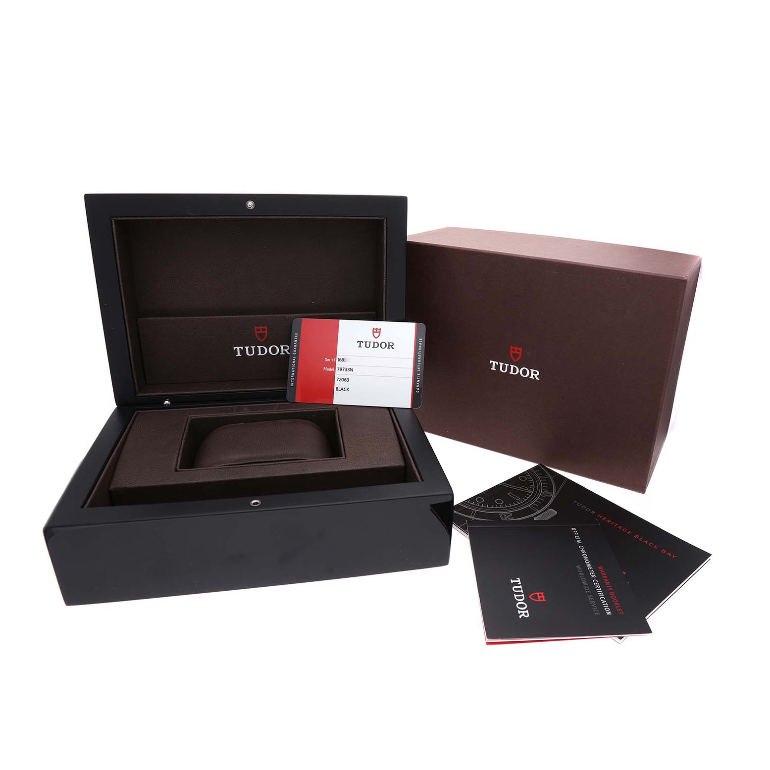The image shows the Tudor Heritage Black Bay 79733N Men's Steel and Gold (two tone) Black Dial watch packaging, including the box, warranty card, and manuals.