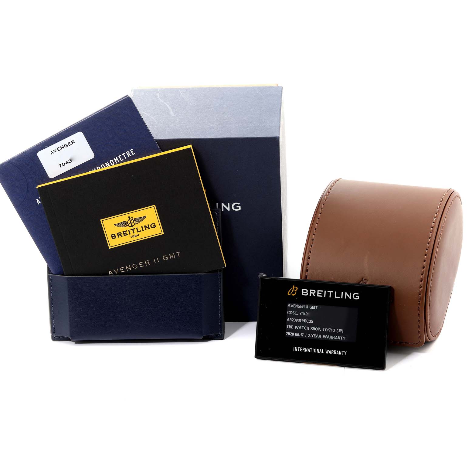 The image displays the accessories for a Breitling Avenger A32390 Men's Stainless Steel Black Dial A32390 Men's Stainless Steel Black Dial watch, including the manuals, warranty card, and a brown watch case.