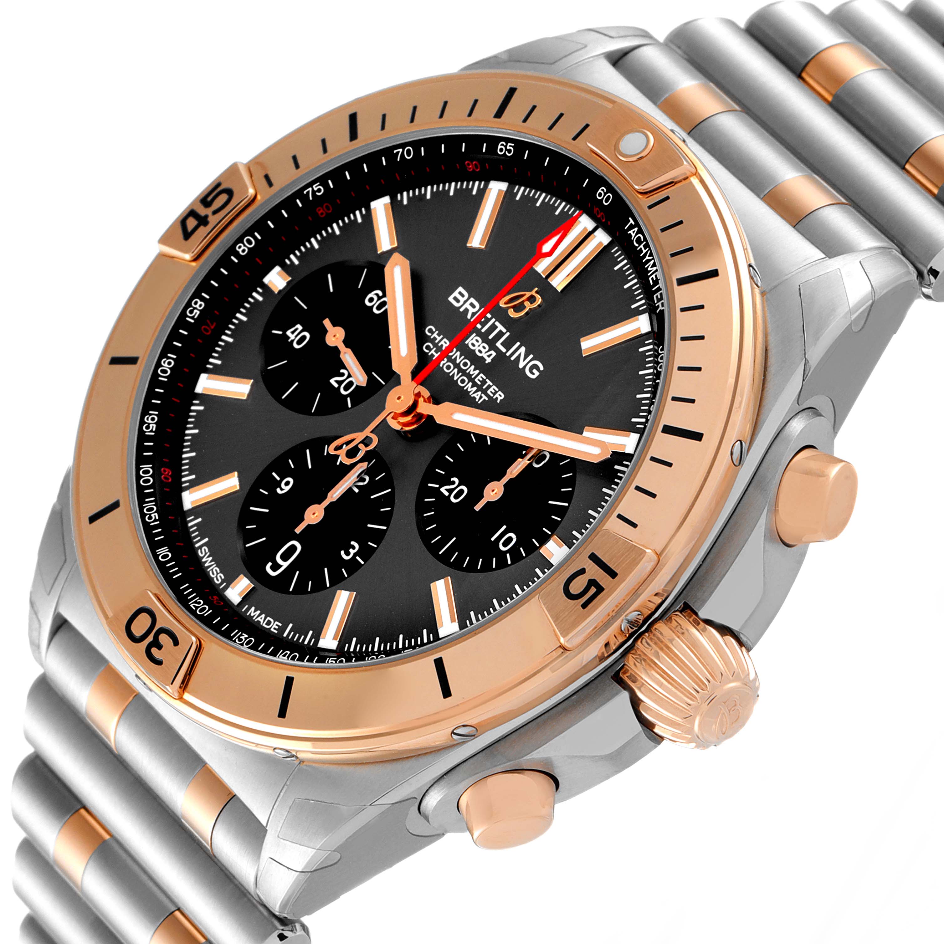 The image shows a close-up angled view of the face and side of the Breitling Chronomat UB0134101C1U1 Men's Steel and Gold (two tone) Grey Dial UB0134101C1U1 Men's Steel and Gold (two tone) Grey Dial watch, highlighting its bezel, dial, and push buttons.