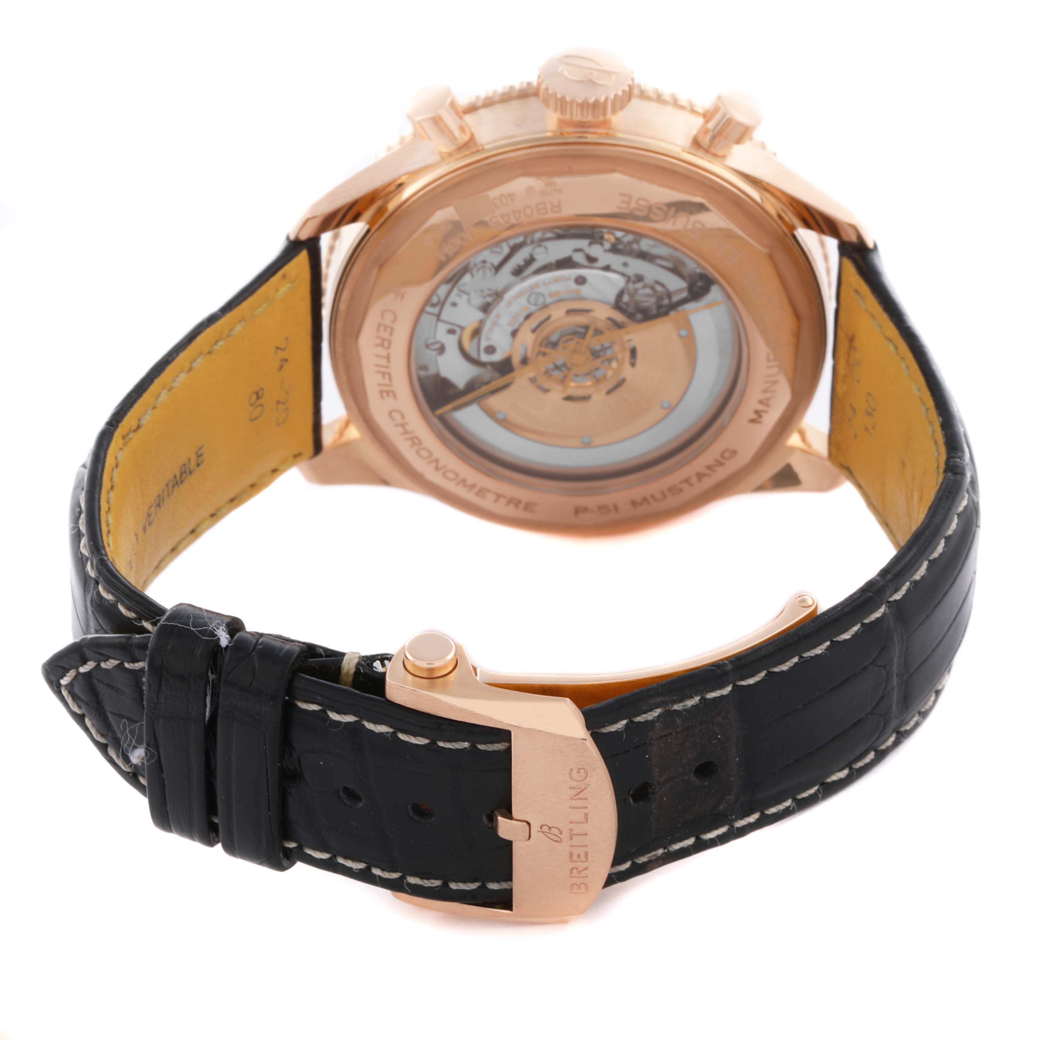 The Breitling Aviator RB04451A1B1X1 Men's Rose Gold Grey Dial RB04451A1B1X1 Men's Rose Gold Grey Dial watch is shown from the back, revealing the movement and case back, with the leather strap and clasp visible.