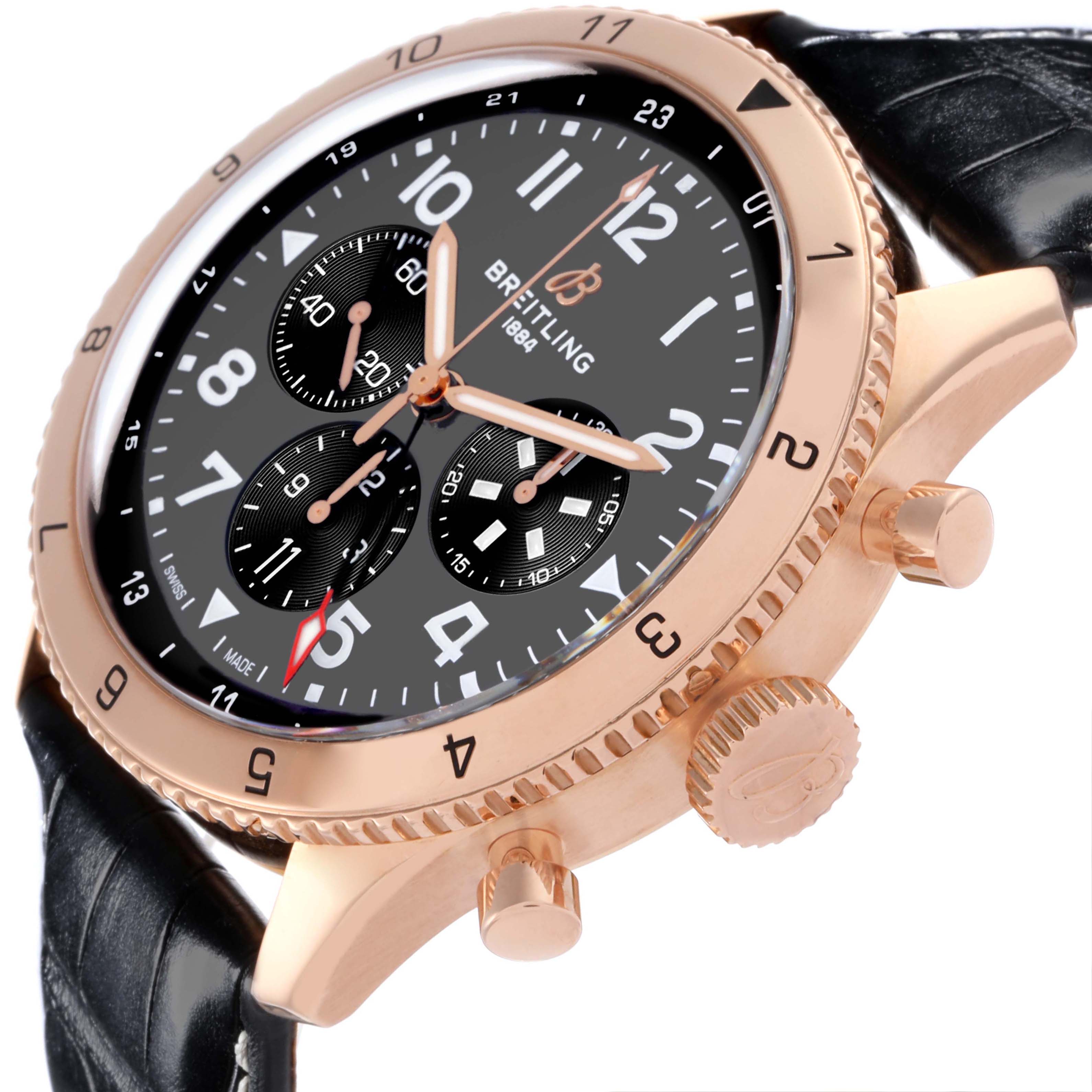 The Breitling Aviator RB04451A1B1X1 Men's Rose Gold Grey Dial RB04451A1B1X1 Men's Rose Gold Grey Dial watch is shown at an angled side view, highlighting the dial, bezel, crown, and pushers.