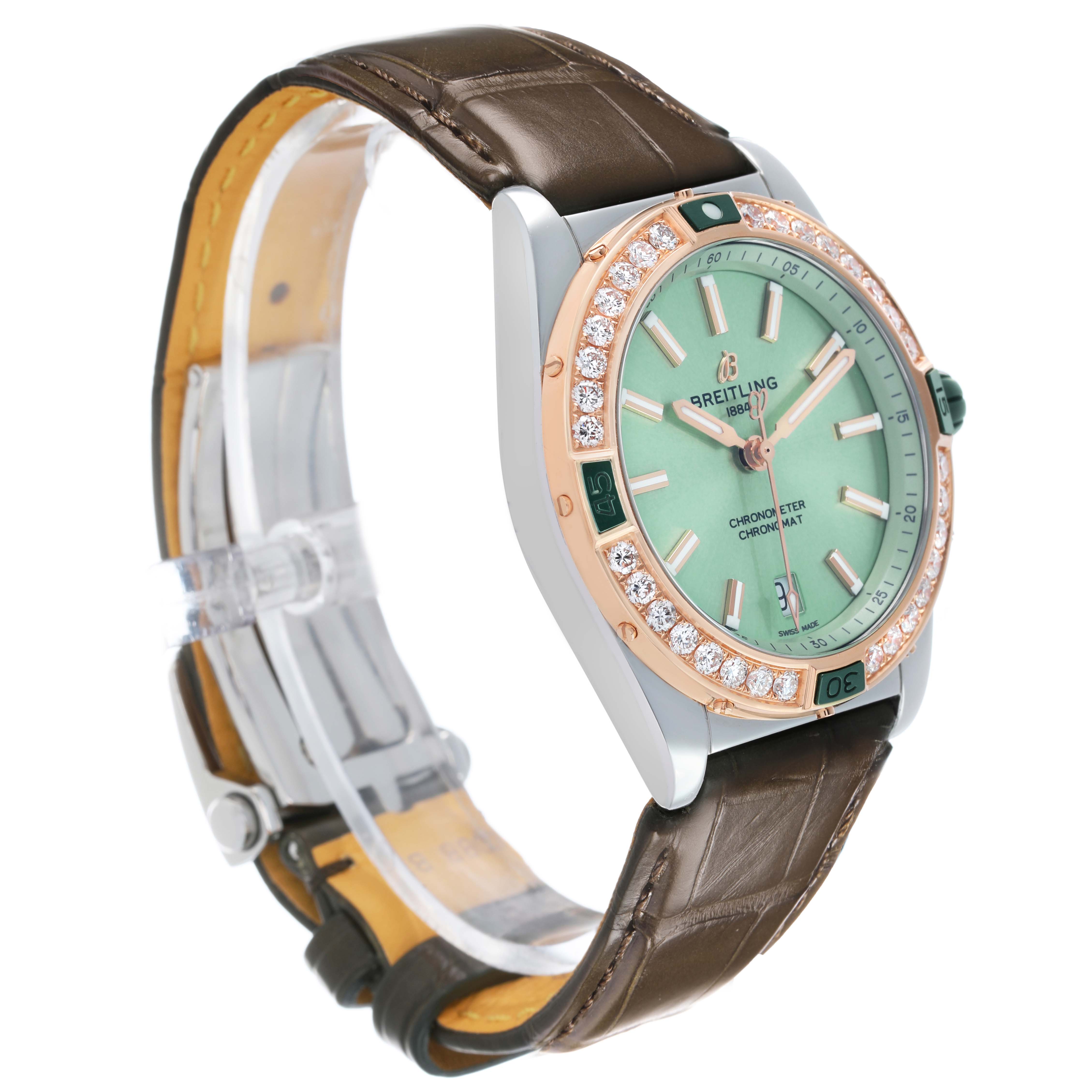 The Breitling U17356 Women's Stainless Steel Green Dial Super Chronomat Steel Rose Gold Diamond Ladies Watch U17356 is shown from a three-quarter angle highlighting the dial, bezel, and strap.