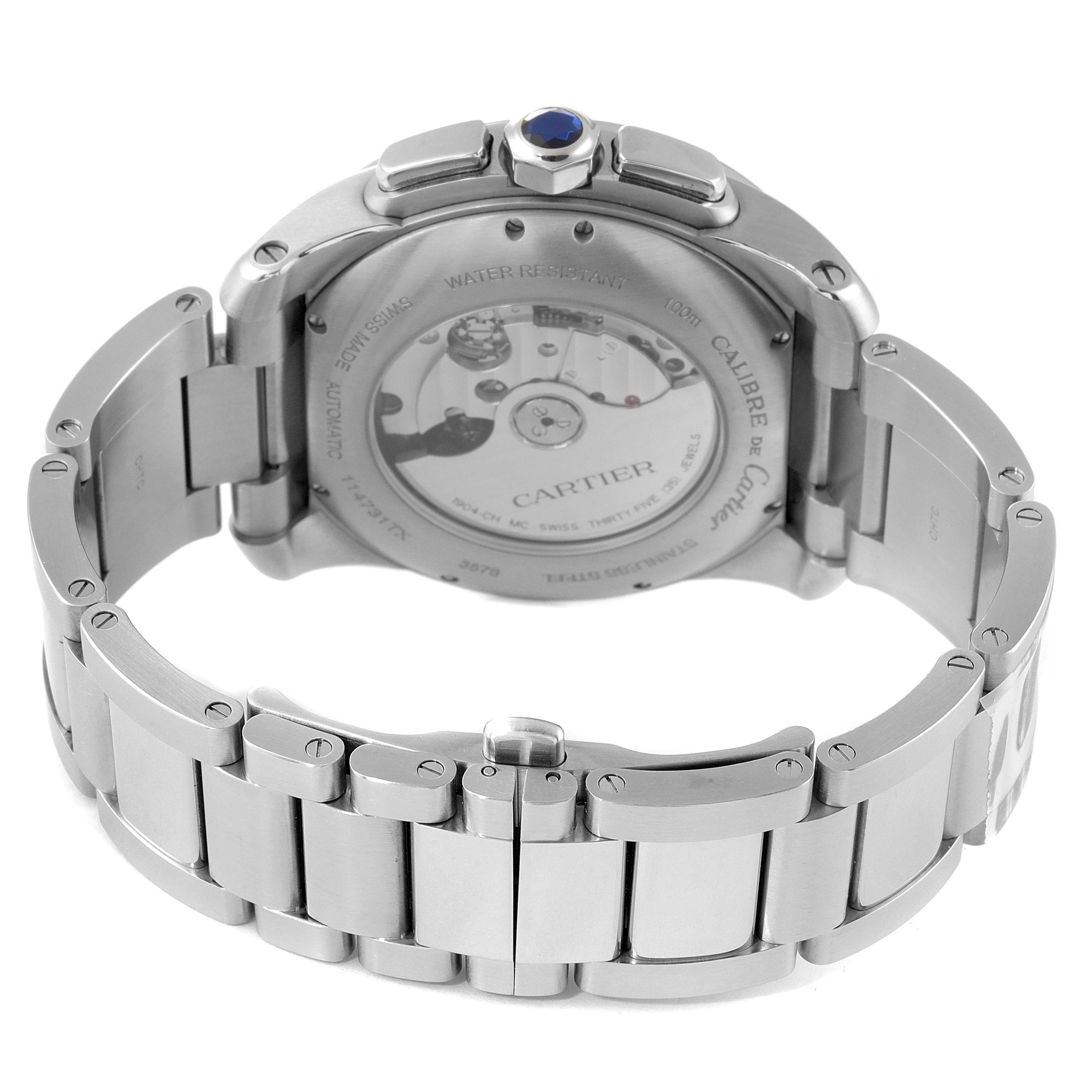 The image shows the back and bracelet of the Calibre de Cartier watch by Cartier, highlighting its transparent case back and metal link bracelet.