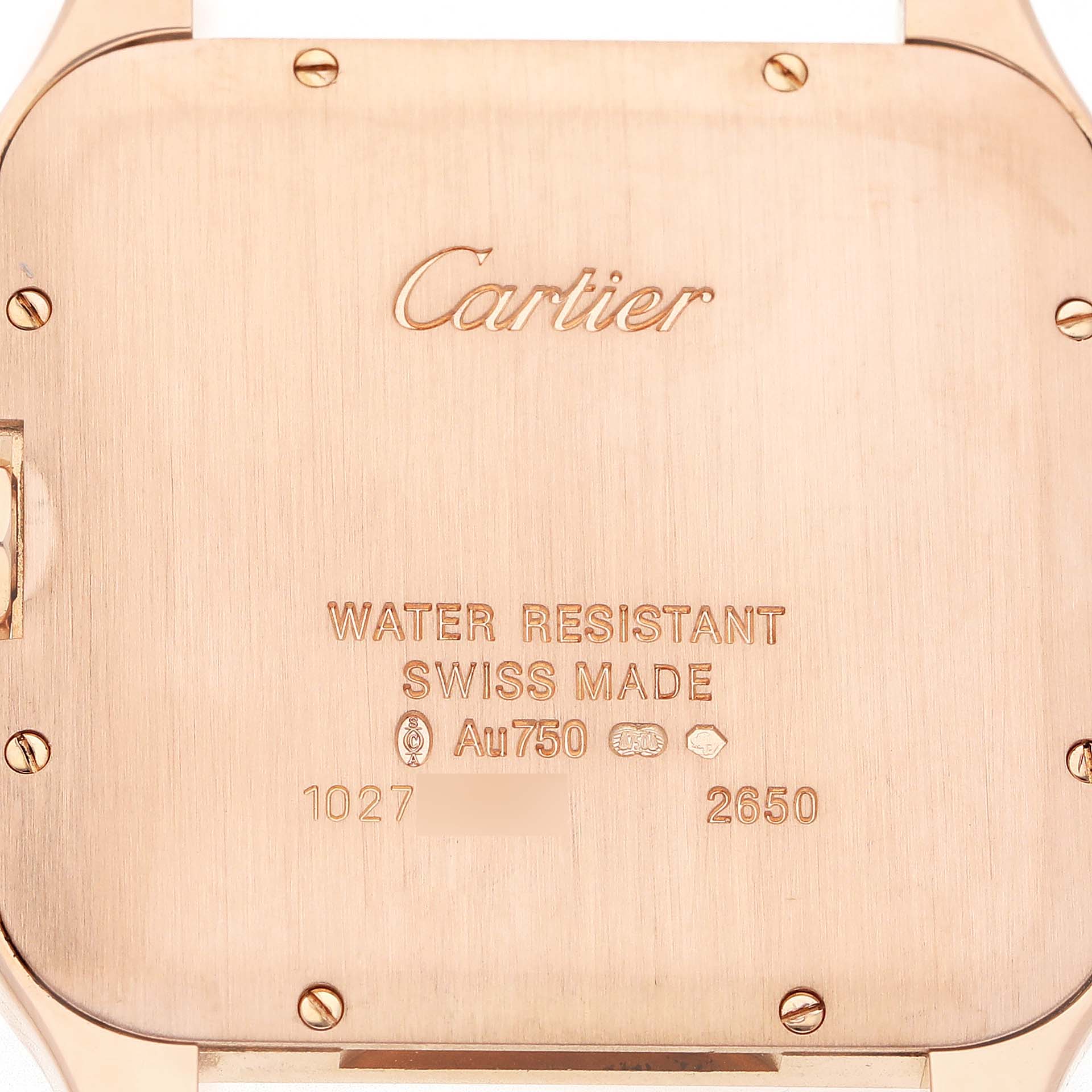 The image shows the back case of the Cartier Santos Dumont WH100651 Men's Rose Gold Silver Dial watch, highlighting engravings and screws.