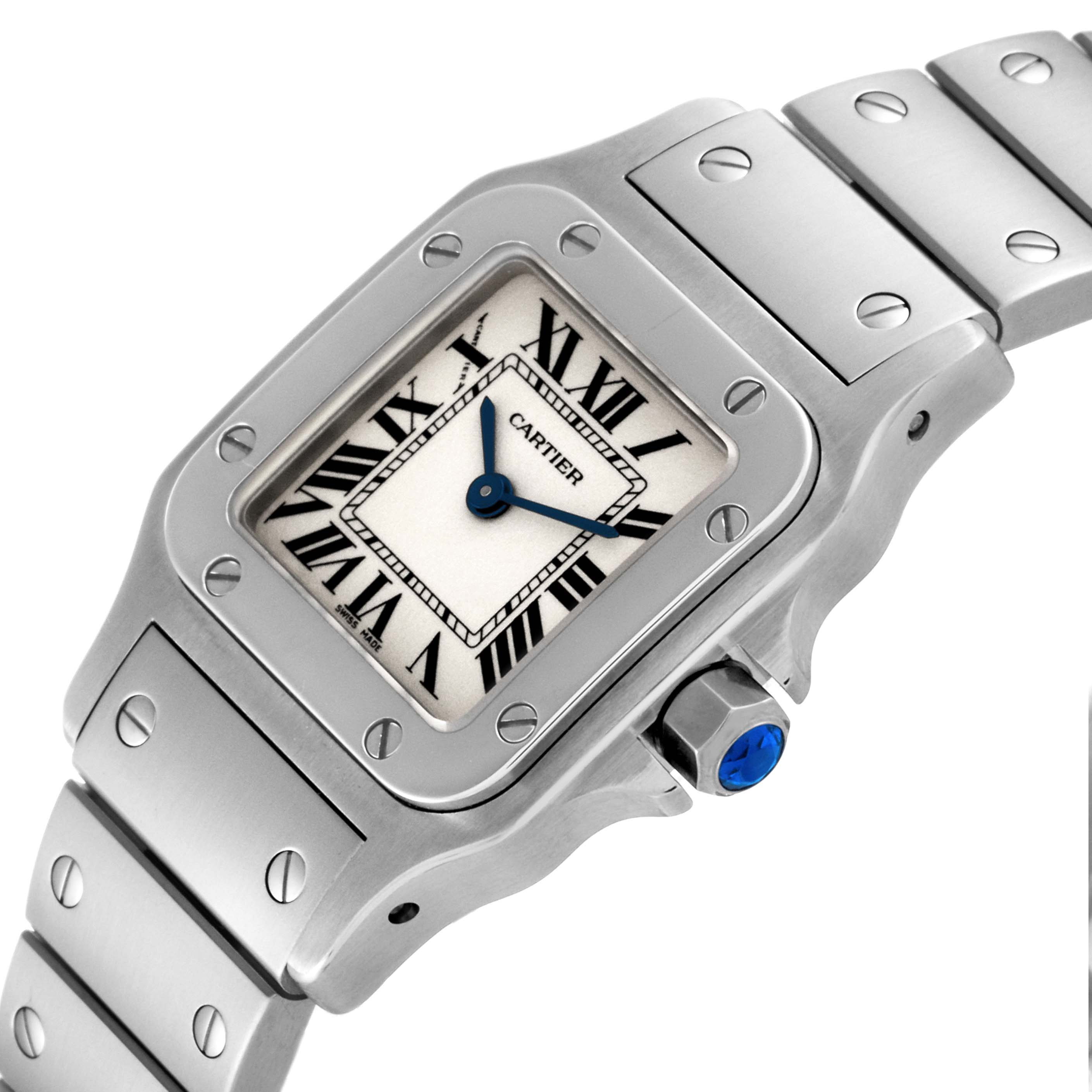 The image shows a close-up of the Cartier Santos W20056D6 Women's Stainless Steel Silver Dial W20056D6 Women's Stainless Steel Silver Dial watch face, bezel, crown, and part of the metal bracelet from an angled perspective.