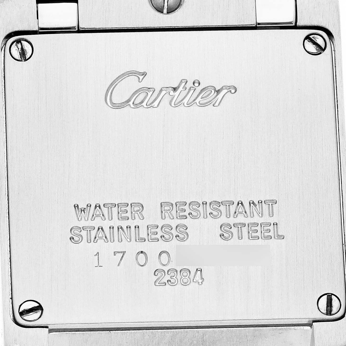 The image shows the back of a Cartier Tank Française watch, highlighting its water-resistant stainless steel case with engraved details.