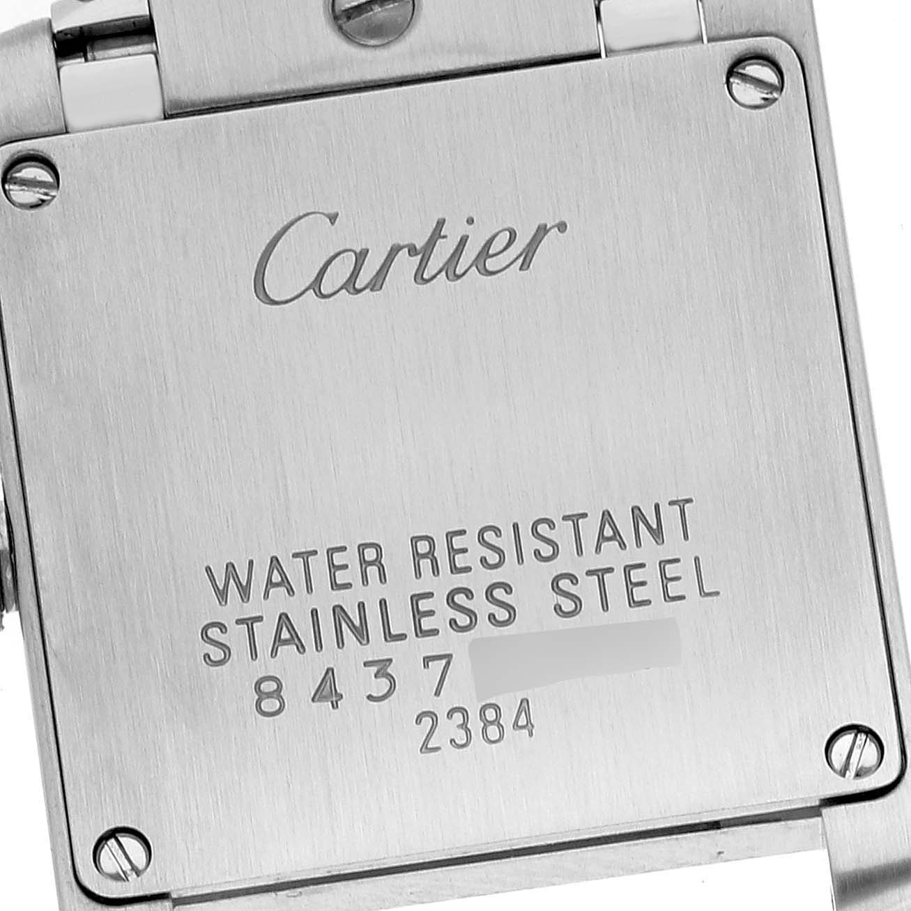 This image shows the stainless steel back case of a Cartier Tank Française watch.