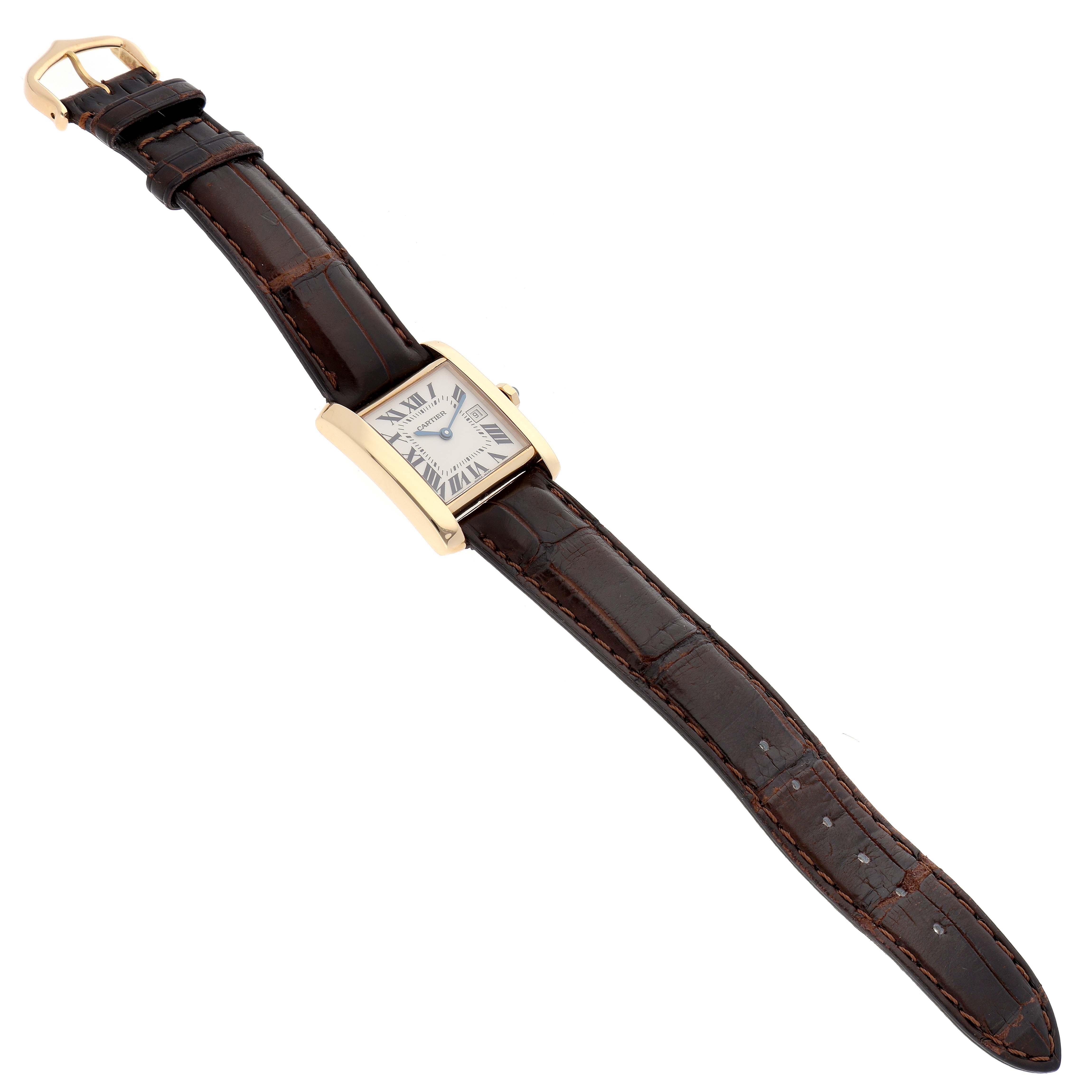 The image shows a Cartier Tank Francaise W5001456 Women's Yellow Gold Silver Dial W5001456 Women's Yellow Gold Silver Dial watch, captured from an angled top-down view, showcasing its face, strap, and clasp.