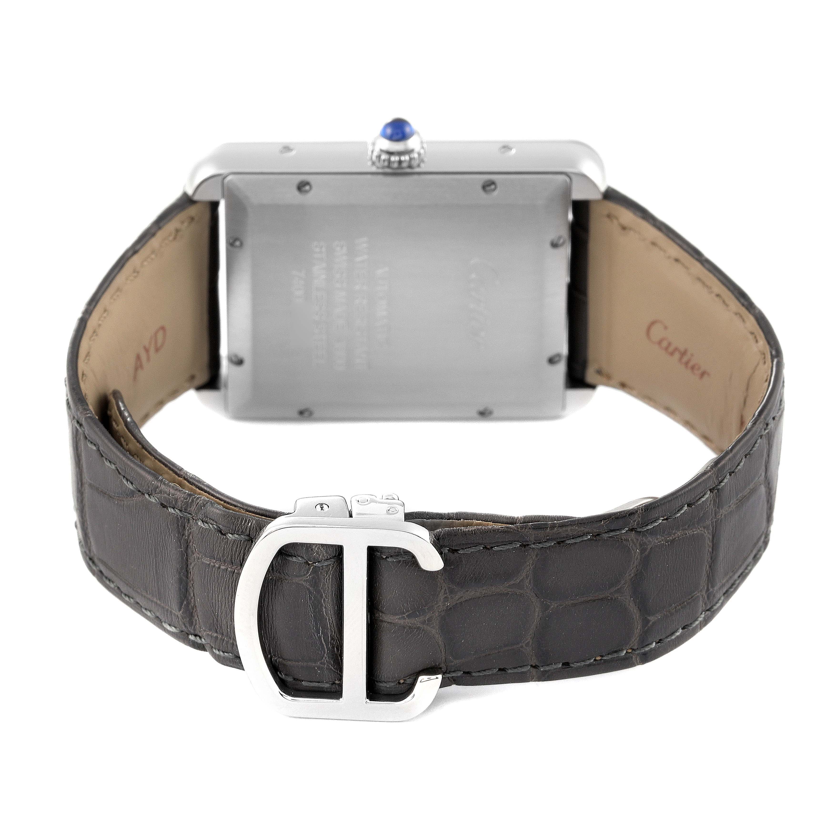 The image shows the back view of a Cartier Tank Solo WSTA0029 Men's Stainless Steel Silver Dial WSTA0029 Men's Stainless Steel Silver Dial watch, highlighting its stainless steel back and leather strap with the Cartier buckle.