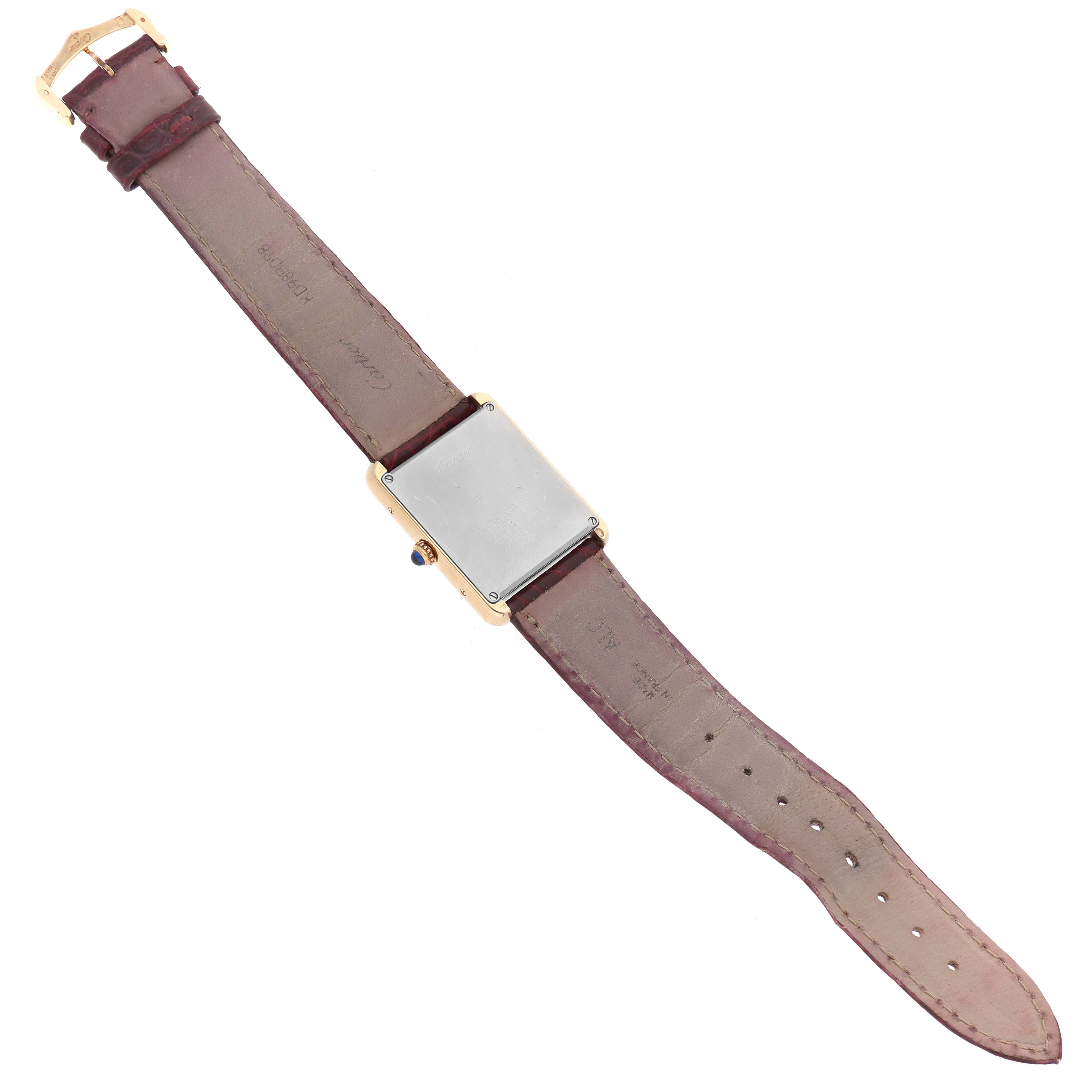 The Cartier Tank Solo W1018855 Men's Steel and Gold (two tone) Silver Dial W1018855 Men's Steel and Gold (two tone) Silver Dial watch is shown from the back, displaying its rectangular case and brown leather strap.