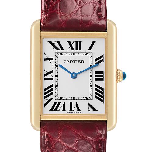 The Cartier Tank Solo watch is shown from a front angle, displaying its face, Roman numerals, blue hands, and red leather strap.