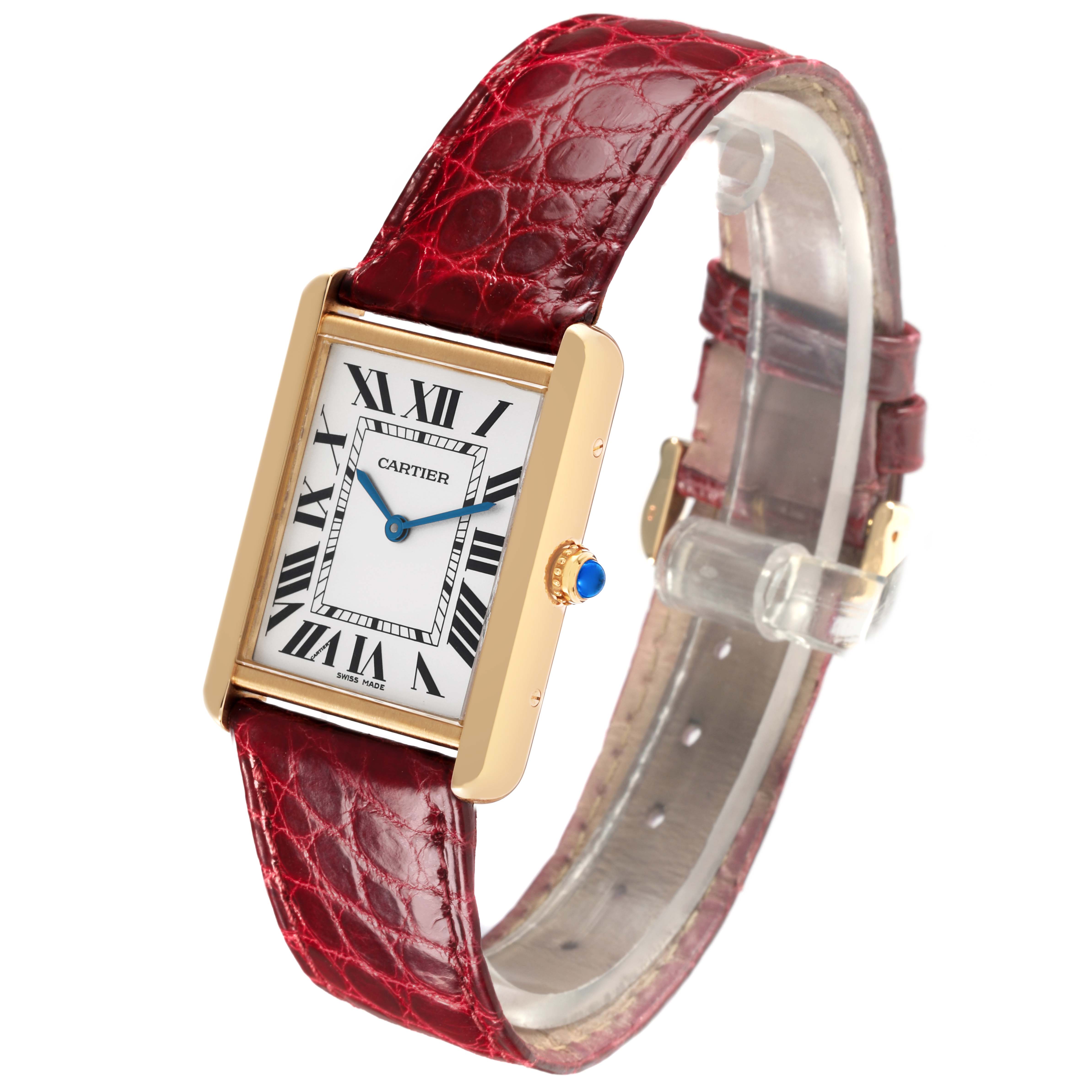 The Cartier Tank Solo W1018855 Men's Steel and Gold (two tone) Silver Dial W1018855 Men's Steel and Gold (two tone) Silver Dial watch is shown at an angle displaying its rectangular face, Roman numerals, red leather strap, and gold-tone casing.