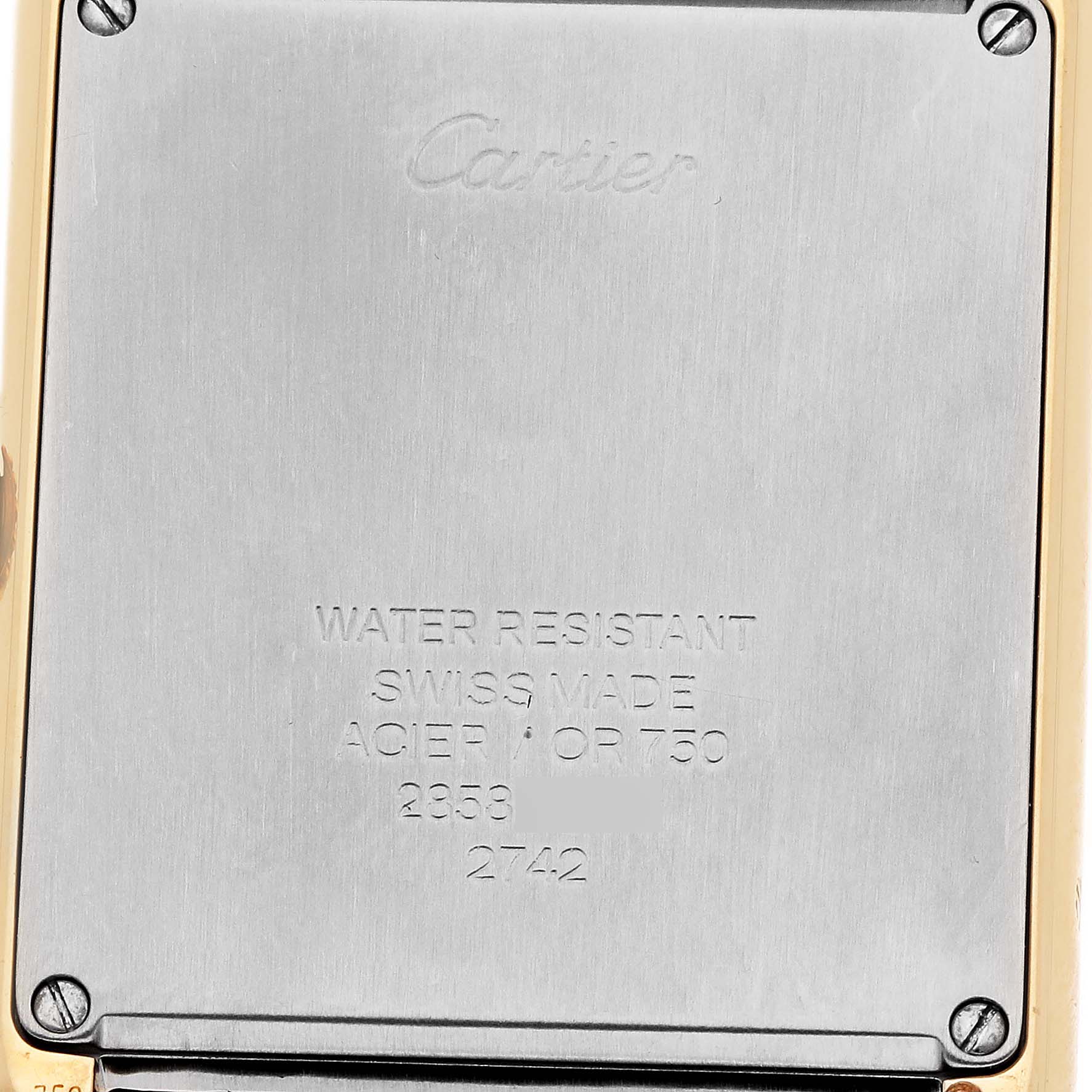 The image shows the back case of the Cartier Tank Solo W1018855 Men's Steel and Gold (two tone) Silver Dial W1018855 Men's Steel and Gold (two tone) Silver Dial watch, featuring engravings and screws at the corners.