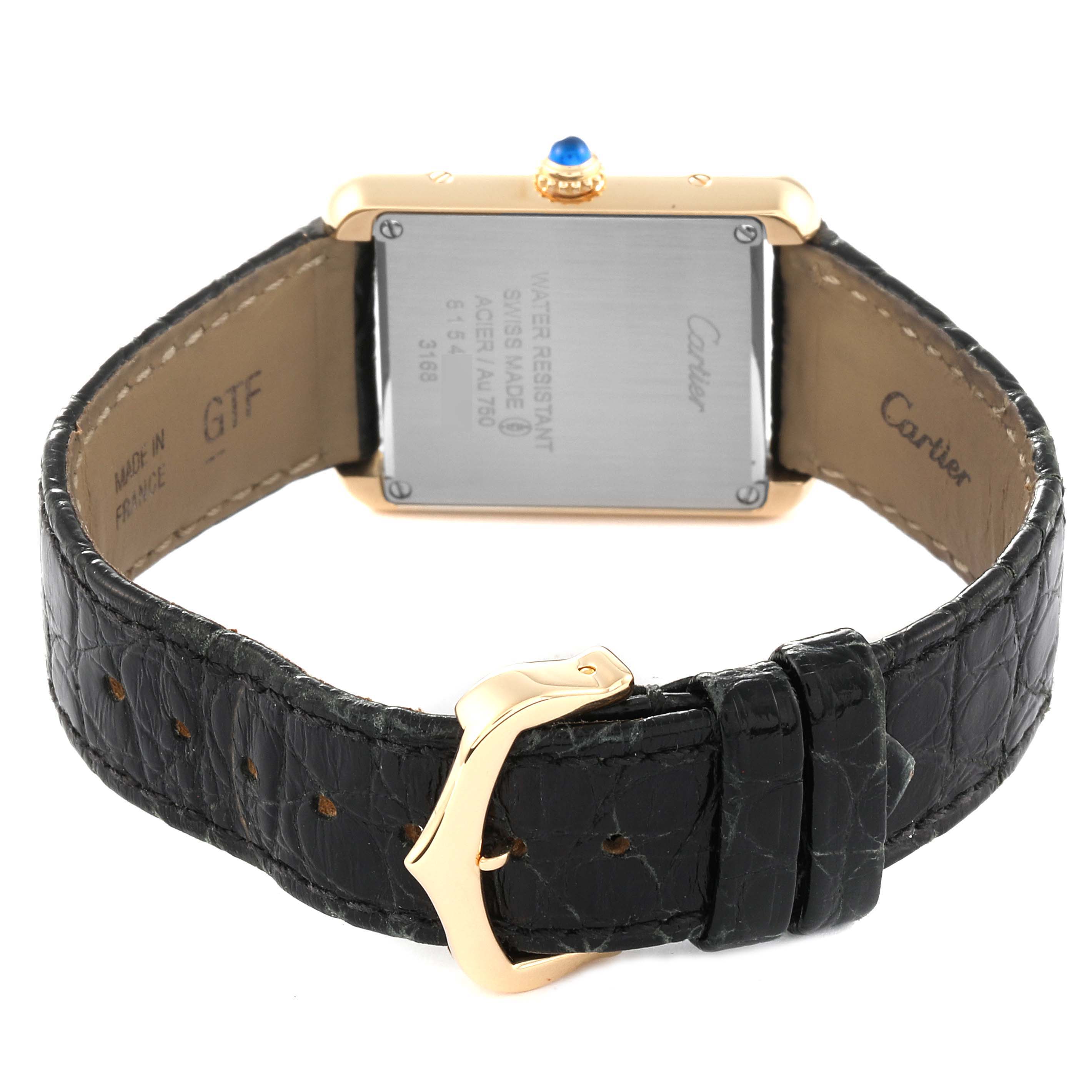 The image shows the back, clasp, and part of the leather strap of a Cartier Tank Solo W5200002 Women
s Steel and Gold (two tone) Silver Dial W5200002 Women
s Steel and Gold (two tone) Silver Dial watch.