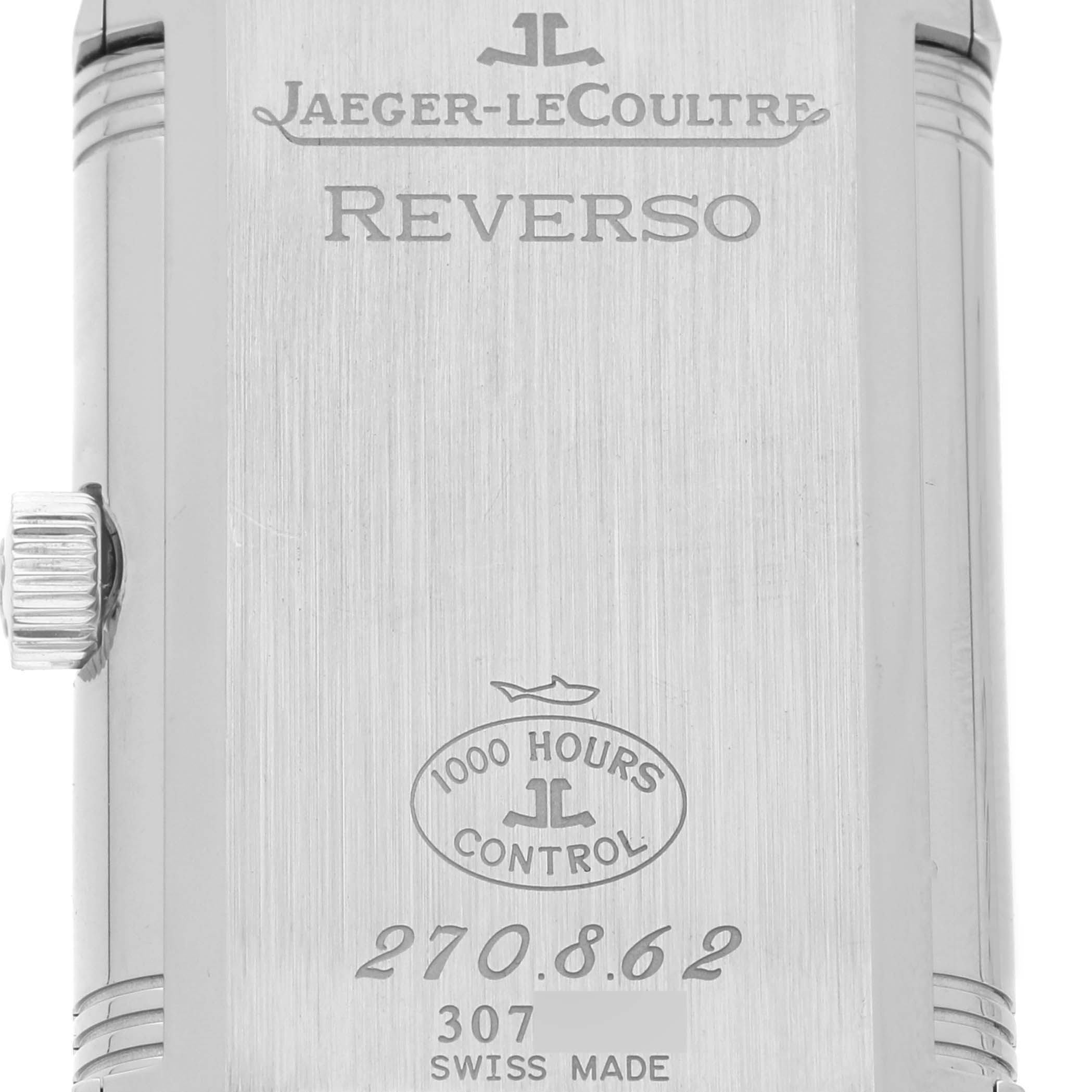 The Reverso watch by Jaeger-LeCoultre is shown from the back with its crown and engraved details visible.