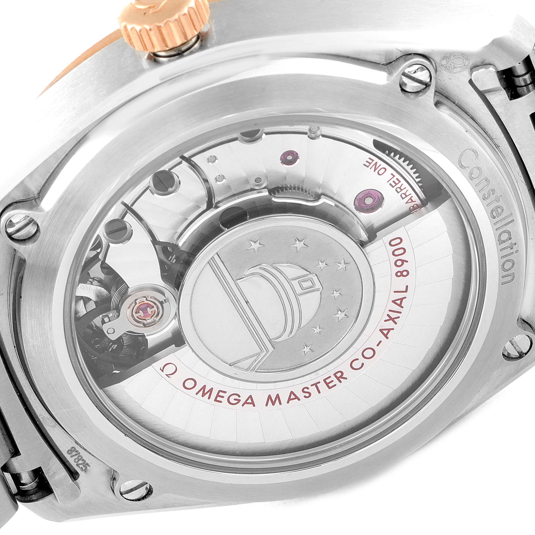 The image shows the back of an Omega Constellation 130.20.39.21.03.001 Men's Steel and Gold (two tone) Blue Dial 130.20.39.21.03.001 Men's Steel and Gold (two tone) Blue Dial watch, highlighting its Co-Axial 8900 movement mechanism.