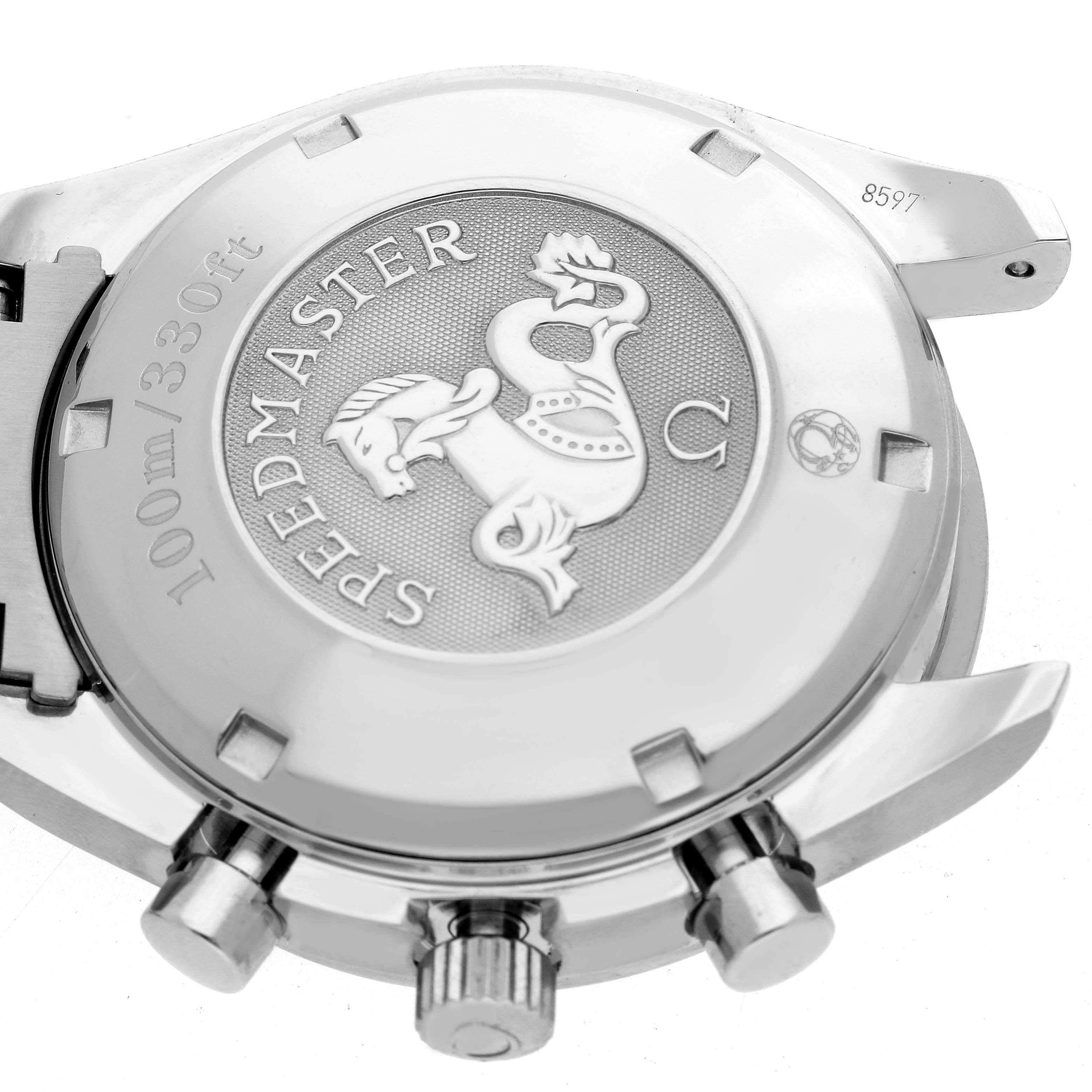 The image shows the back case of an Omega Speedmaster watch with visible crown and pushers.