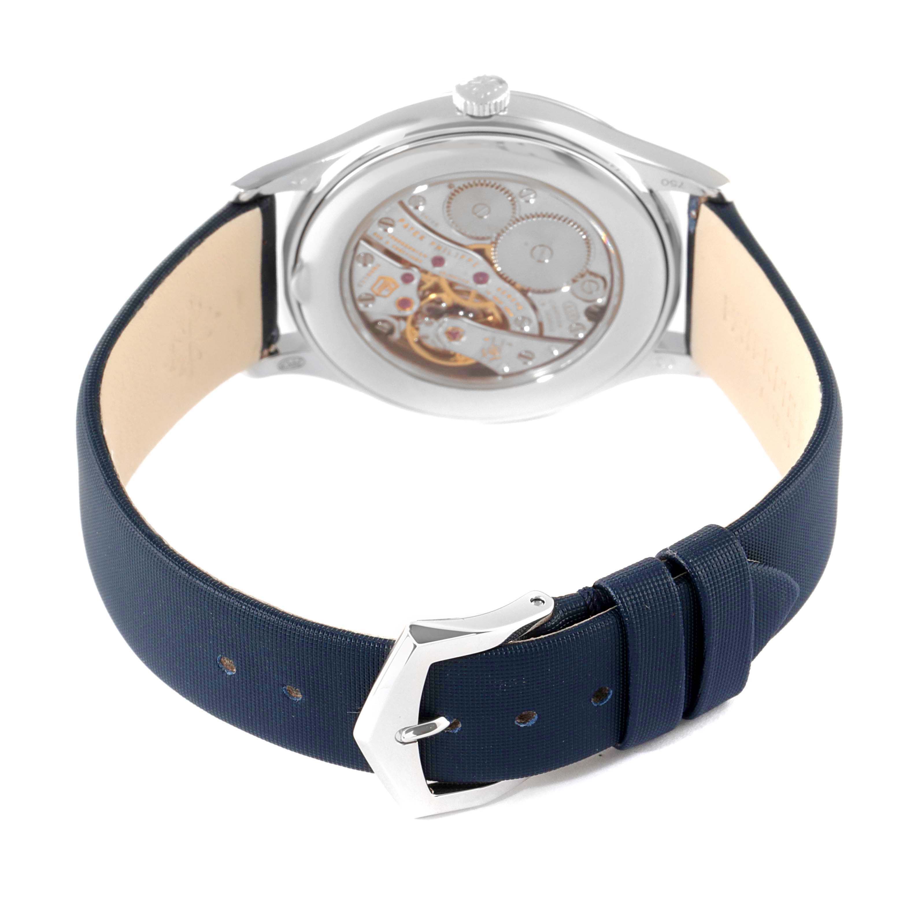 The image shows the back view of a Patek Philippe Calatrava 4897G-001 Women's White Gold Blue Dial 4897G-001 Women's White Gold Blue Dial watch, displaying the movement and part of the strap.