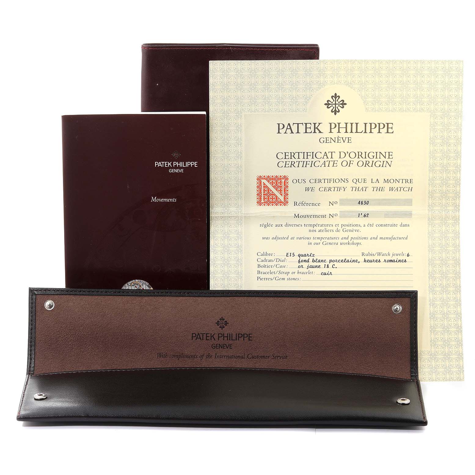 This image shows the certificate, manual, and leather case for the Patek Philippe Golden Ellipse 4830 Women's Yellow Gold White Dial 4830 Women's Yellow Gold White Dial watch.