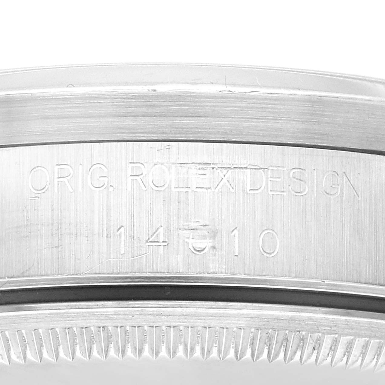 The image shows a close-up of the side of the Rolex Air-King 14010 Men's Stainless Steel Blue Dial 14010 Men's Stainless Steel Blue Dial watch case, displaying the engraved text "ORIG ROLEX DESIGN 14010."