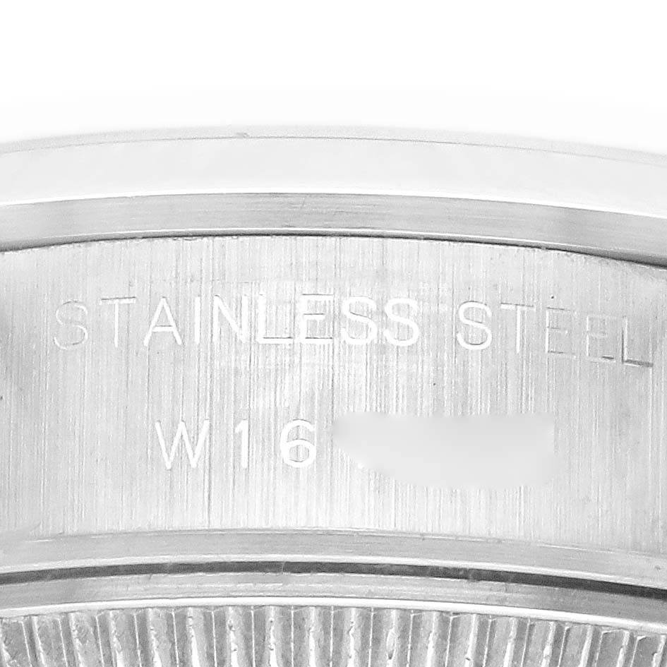 The image shows a close-up of the side engraving on a Rolex Date 69160 Women's Stainless Steel Blue Dial 69160 Women's Stainless Steel Blue Dial model, highlighting the "STAINLESS STEEL" text.