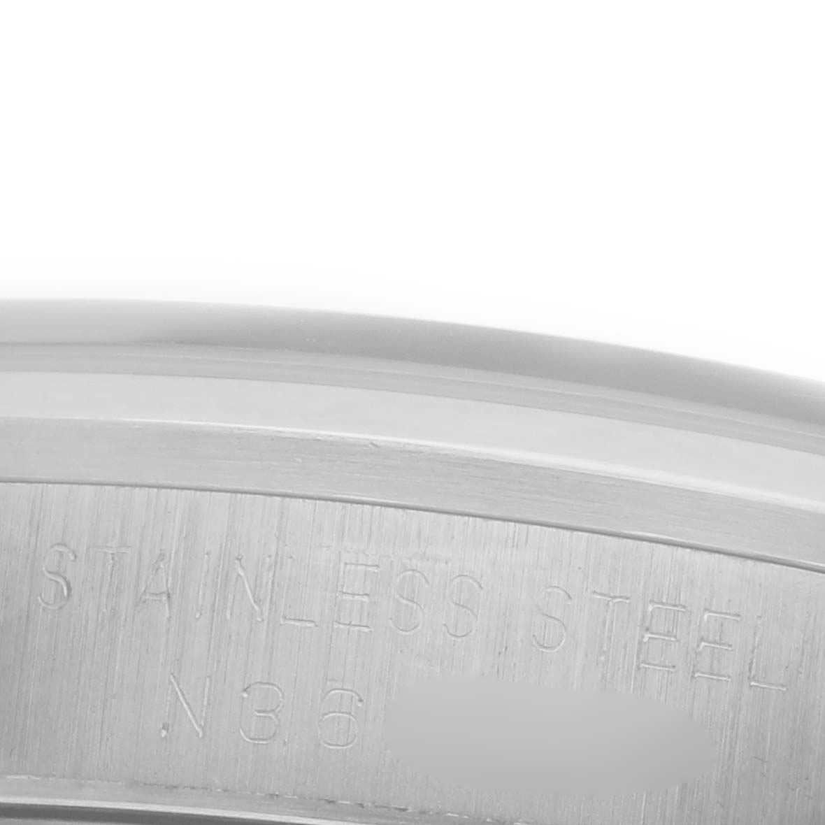 The image shows a close-up of the inner rim of a Rolex Date 15200 Men's Stainless Steel Blue Dial 15200 Men's Stainless Steel Blue Dial watch case, highlighting the "Stainless Steel" engraving.