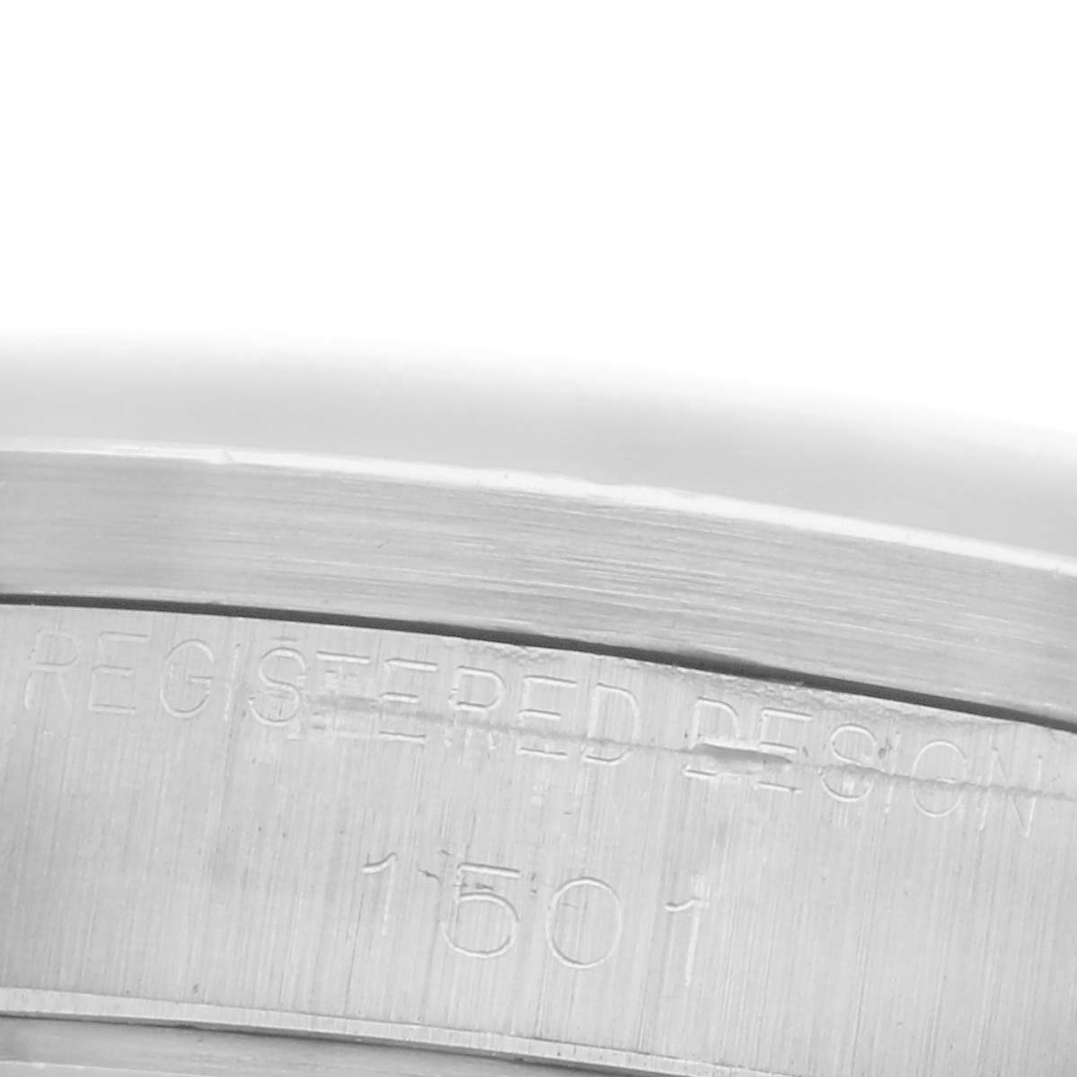 The image shows a close-up of the case side with engravings on the Rolex Date 1501 Men's Stainless Steel Silver Dial 1501 Men's Stainless Steel Silver Dial model.