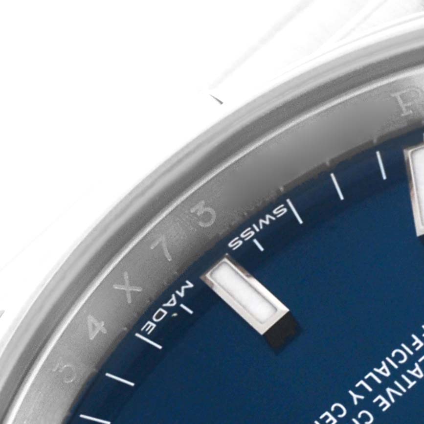 The image shows a close-up of the dial and partial bezel of a Rolex Date 115200 Men's Stainless Steel Blue Dial 115200 Men's Stainless Steel Blue Dial model watch, focusing on the "SWISS MADE" text and hour markers.