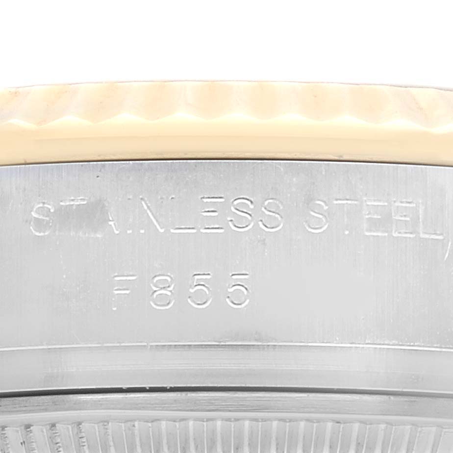 This image shows a close-up of the stainless steel bezel and part of the fluted edge of a Rolex Datejust 179173 Women's Steel and Gold (two tone) Silver Dial 179173 Women's Steel and Gold (two tone) Silver Dial watch.