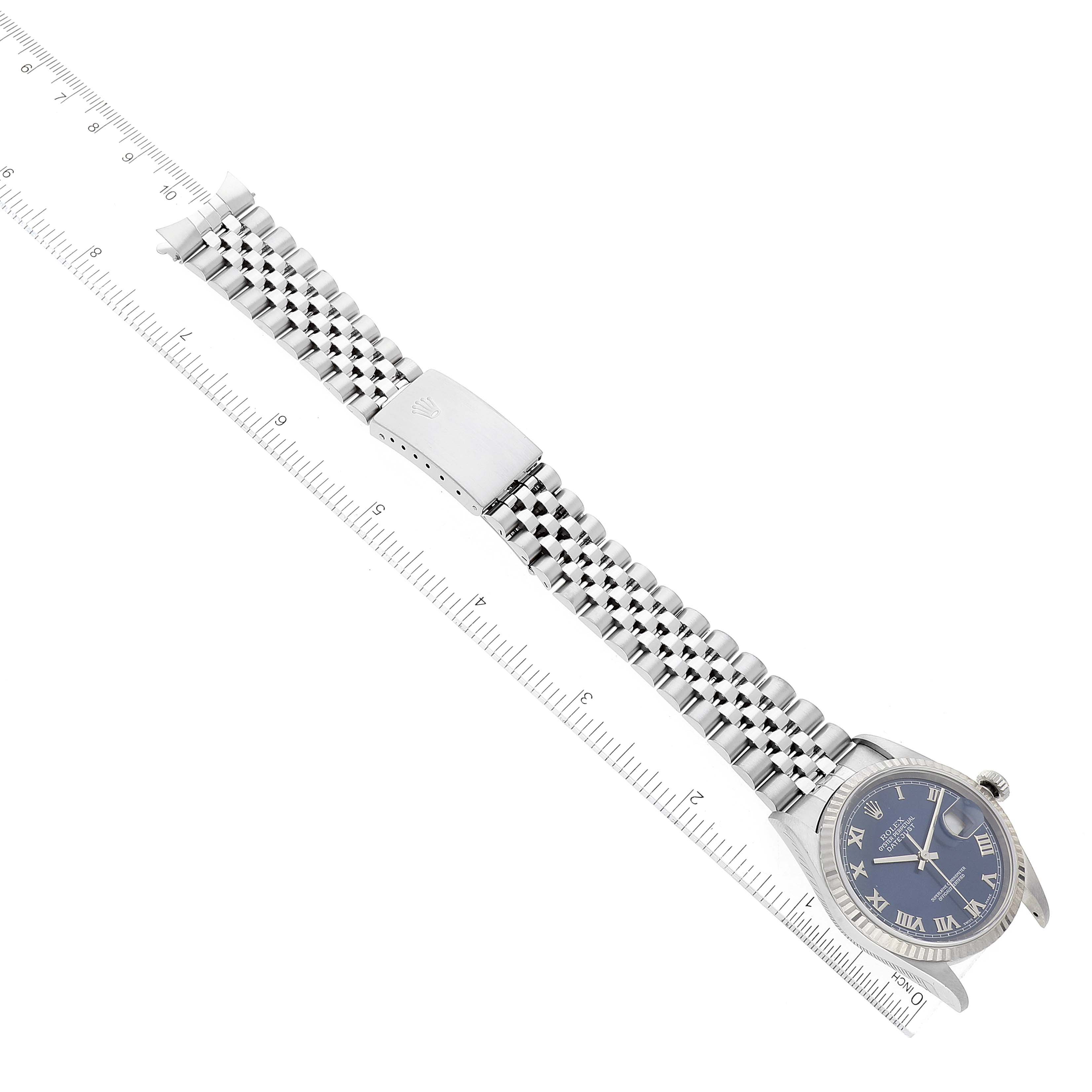This image shows a Rolex Datejust 16234 Men's Stainless Steel Blue Dial 16234 Men's Stainless Steel Blue Dial watch lying flat, showcasing the dial and full bracelet with a ruler for scale.