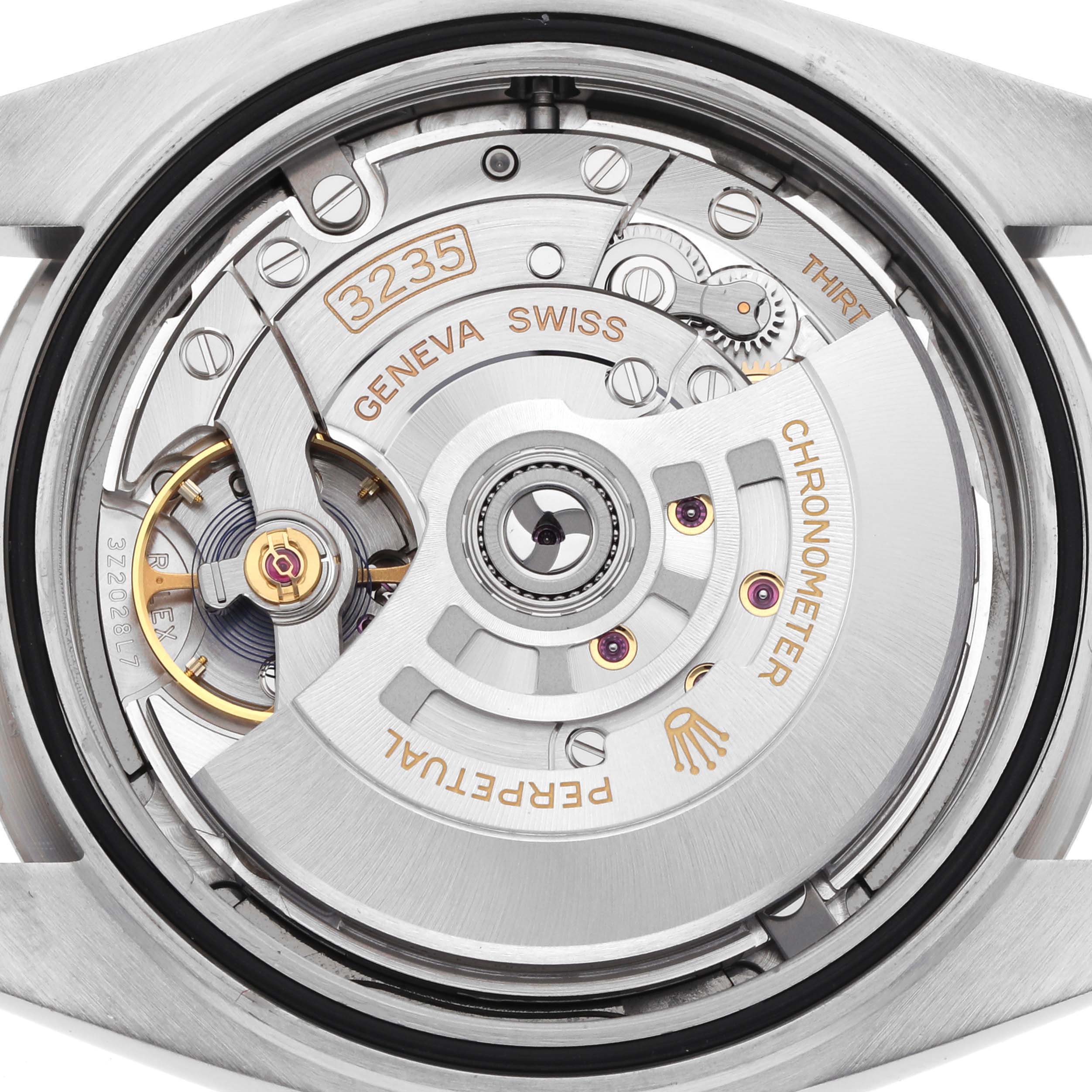 The image shows the movement of a Rolex Datejust 41 126334 Men's Stainless Steel Grey Dial 126334 Men's Stainless Steel Grey Dial, focusing on the intricate mechanics and rotor assembly.