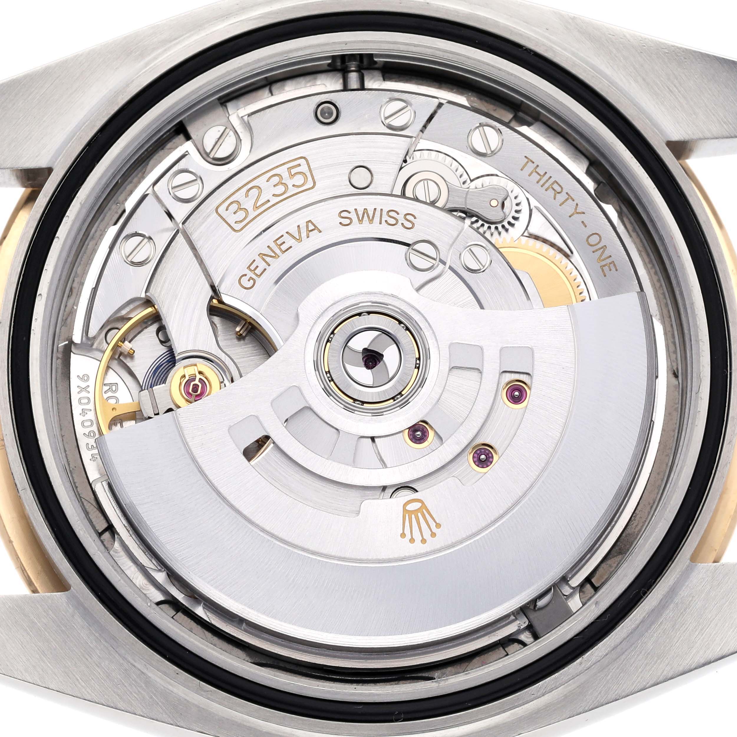 The image shows the Rolex Datejust 41 126303 Men's Steel and Gold (two tone) Grey Dial 126303 Men's Steel and Gold (two tone) Grey Dial's movement from a back angle, highlighting its intricate internal mechanics.