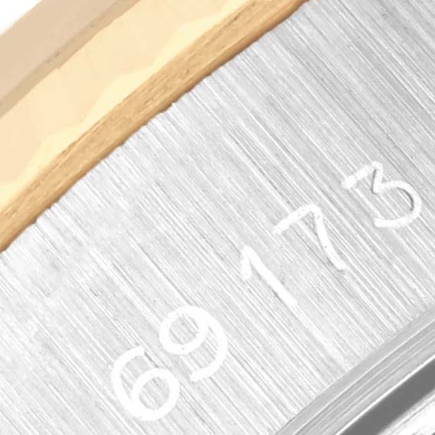 The image shows a close-up of the Rolex Datejust 69173 Women's Steel and Gold (two tone) Champagne Dial 69173 Women's Steel and Gold (two tone) Champagne Dial watch, focusing on part of the case with engraved numbers.