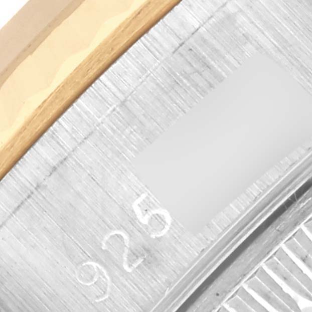 The image shows a close-up of the bezel and part of the case of a Rolex Datejust 69173 Women's Steel and Gold (two tone) Champagne Dial 69173 Women's Steel and Gold (two tone) Champagne Dial, featuring stainless steel and gold elements.