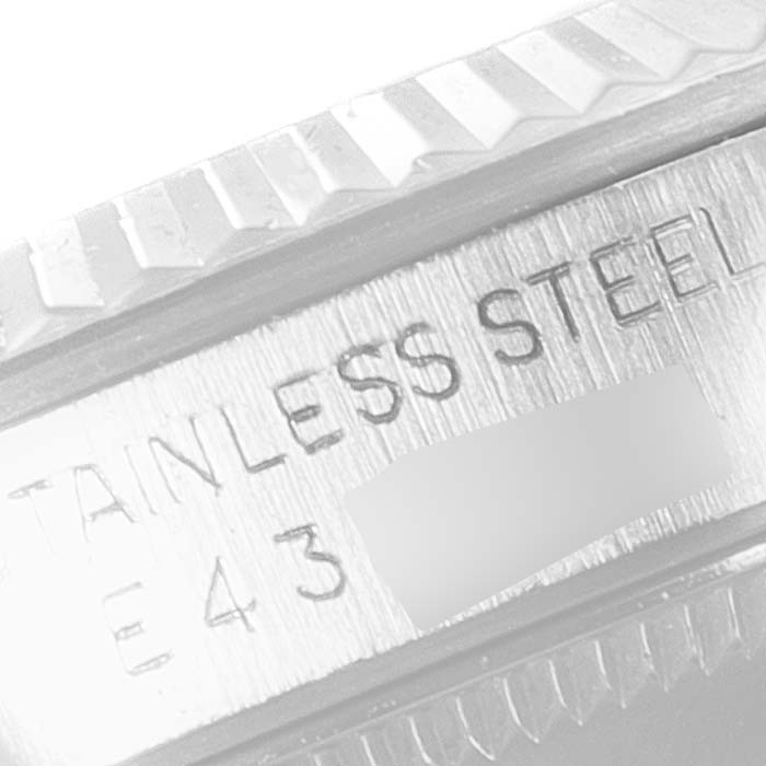 This close-up image shows the engraved "STAINLESS STEEL" text and serial number on the Mid-Size Rolex watch case.
