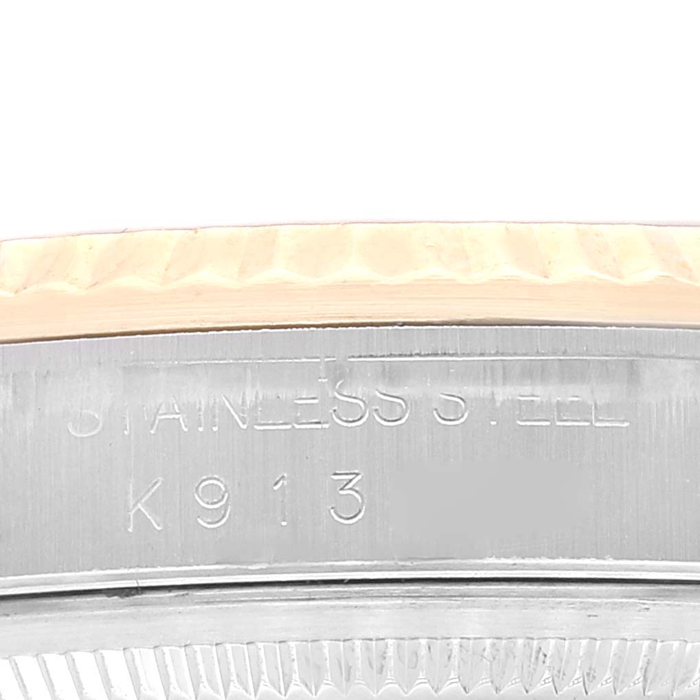 The image shows a close-up of the case side and edge of the bezel of a Rolex Datejust 16233 Men's Steel and Gold (two tone) Black Dial 16233 Men's Steel and Gold (two tone) Black Dial watch.
