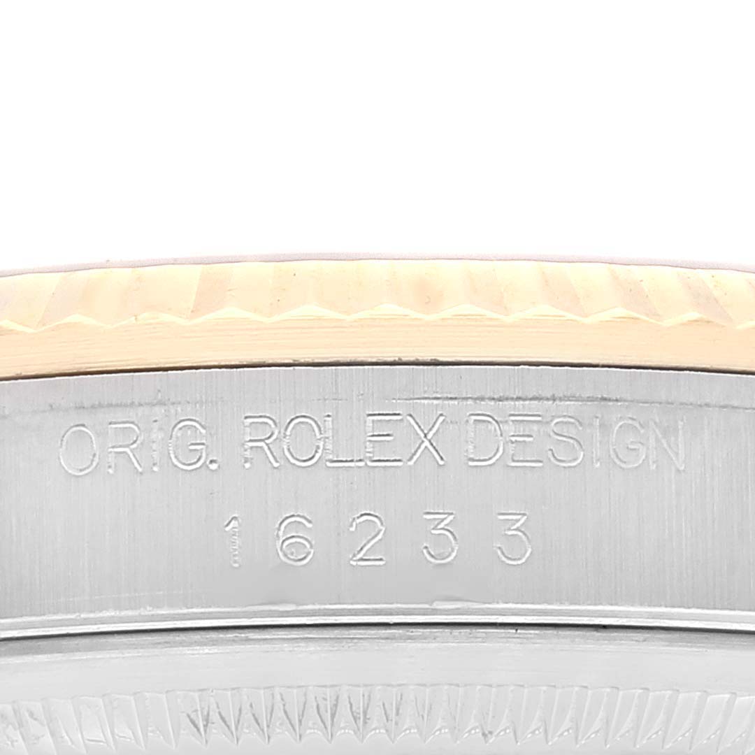 This close-up image shows the case side and bezel of a Rolex Datejust 16233 Men's Steel and Gold (two tone) Black Dial 16233 Men's Steel and Gold (two tone) Black Dial model featuring the engraving "ORIG. ROLEX DESIGN 16233".