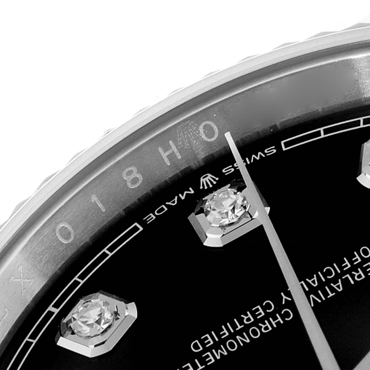 This close-up image of a Rolex Datejust 126234 Men
s Stainless Steel Black Dial 126234 Men
s Stainless Steel Black Dial watch shows part of the bezel, dial, diamond hour markers, and minute hand.