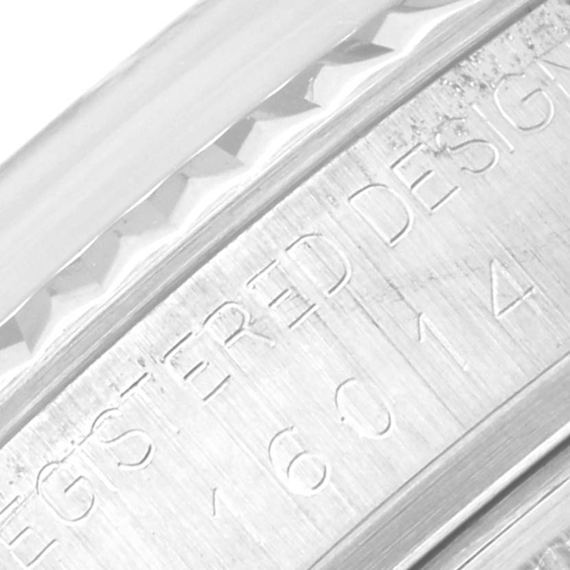 The image shows a close-up of the edge and engraved serial number on the bezel of a Vintage Collection Rolex watch.