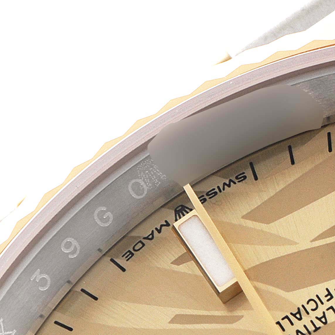 This close-up image of a Rolex Datejust 126233 Men's Steel and Gold (two tone) Champagne Dial 126233 Men's Steel and Gold (two tone) Champagne Dial watch shows parts of the dial, bezel, and marker in a detailed angle.