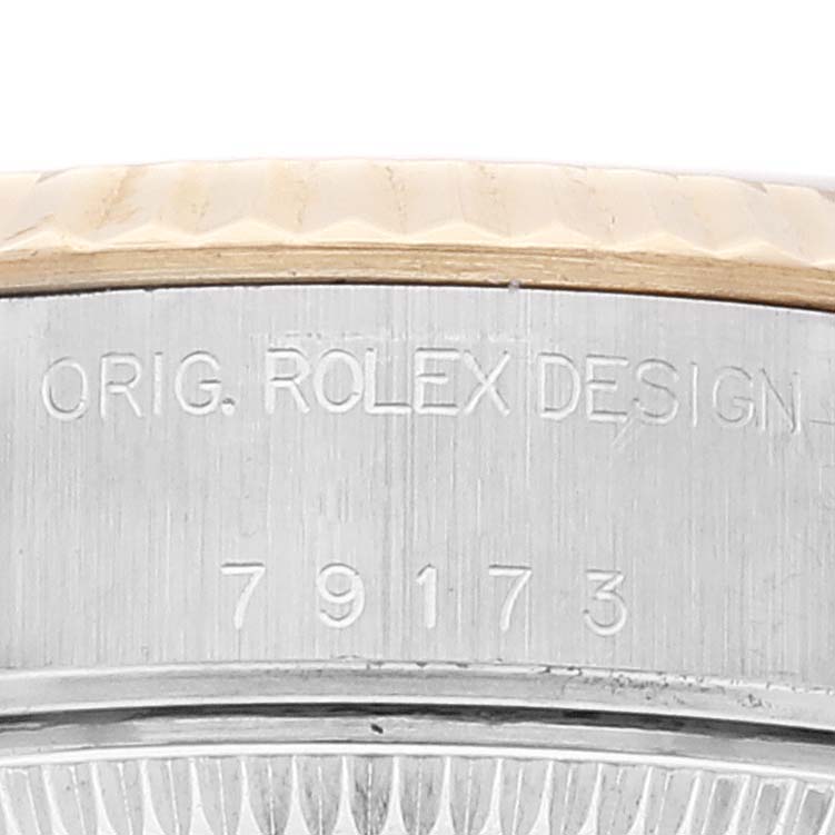 The image shows a close-up of the case side of a Rolex Datejust 79173 Women's Steel and Gold (two tone) Silver Dial 79173 Women's Steel and Gold (two tone) Silver Dial, highlighting the engraved original design and model number "79173."