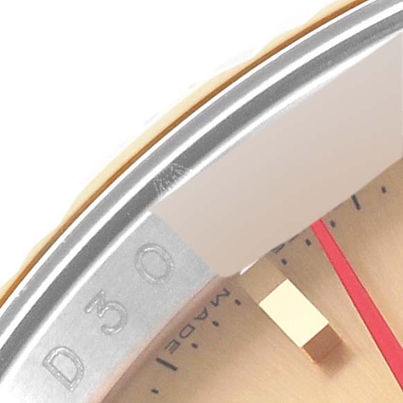 The image shows a close-up of the bezel and part of the dial of a Rolex Turn-o-Graph 116263 Men's Steel and Gold (two tone) Champagne Dial 116263 Men's Steel and Gold (two tone) Champagne Dial watch.