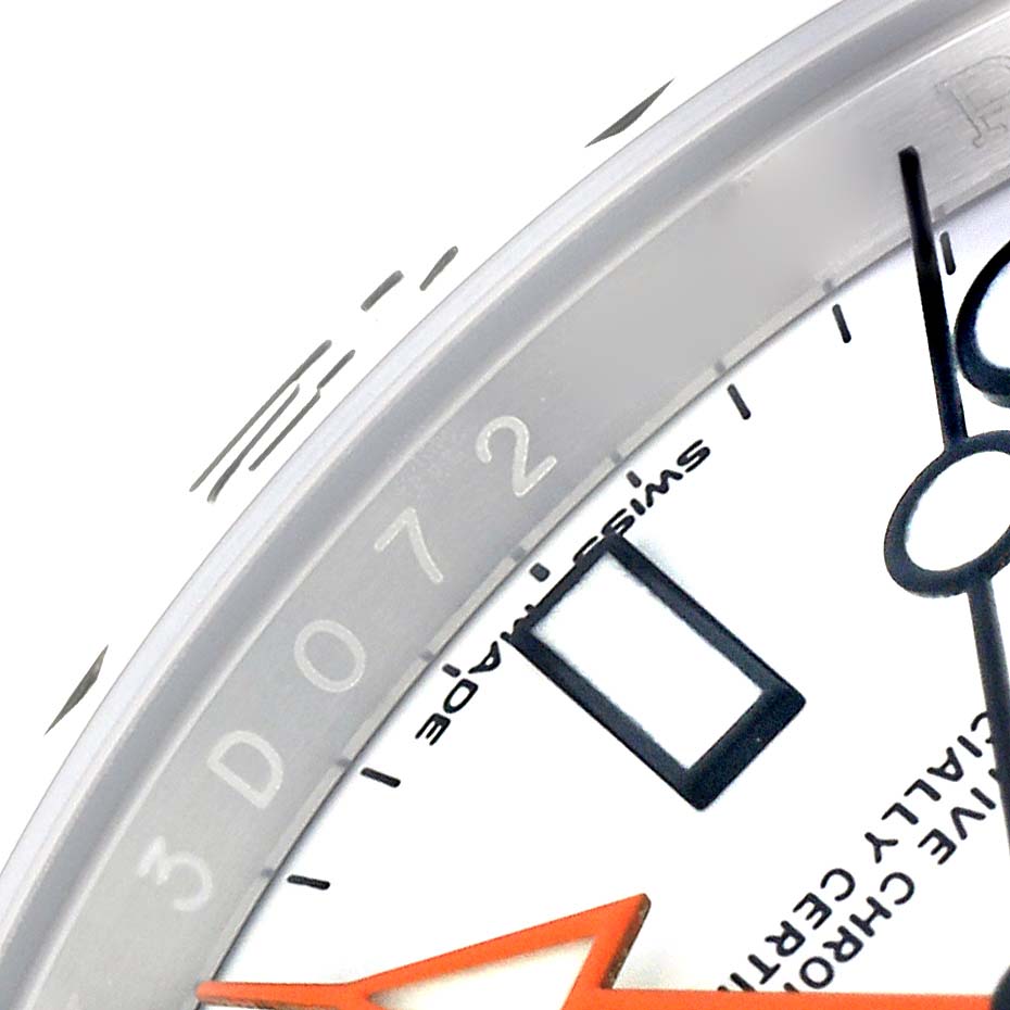 The image shows a close-up of the dial of the Rolex Explorer 216570 Men's Stainless Steel White Dial 216570 Men's Stainless Steel White Dial, highlighting the 24-hour hand and part of the bezel.