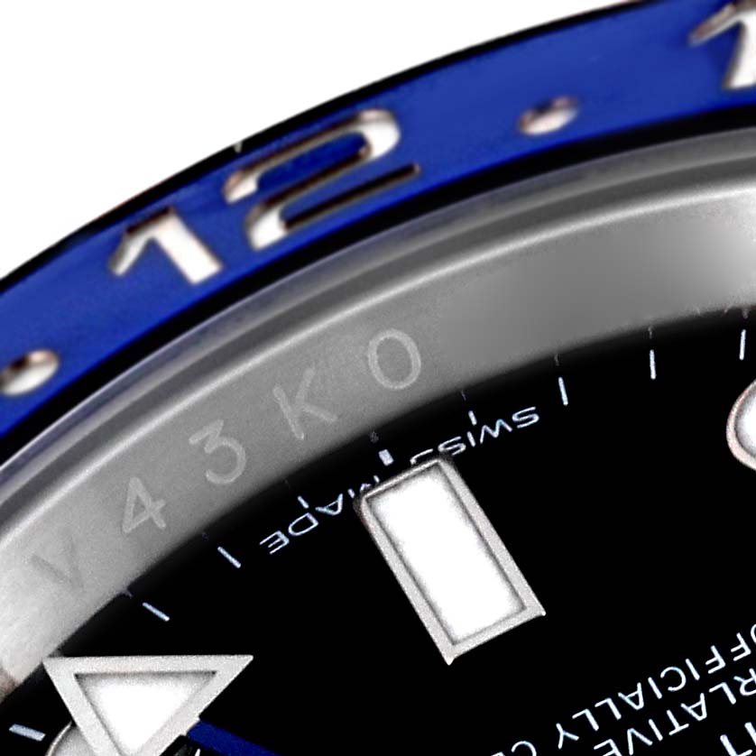 The close-up image of the Rolex GMT-Master 116710 Men's Stainless Steel Black Dial 116710 Men's Stainless Steel Black Dial watch shows part of the blue bezel and hour markers on the dial.